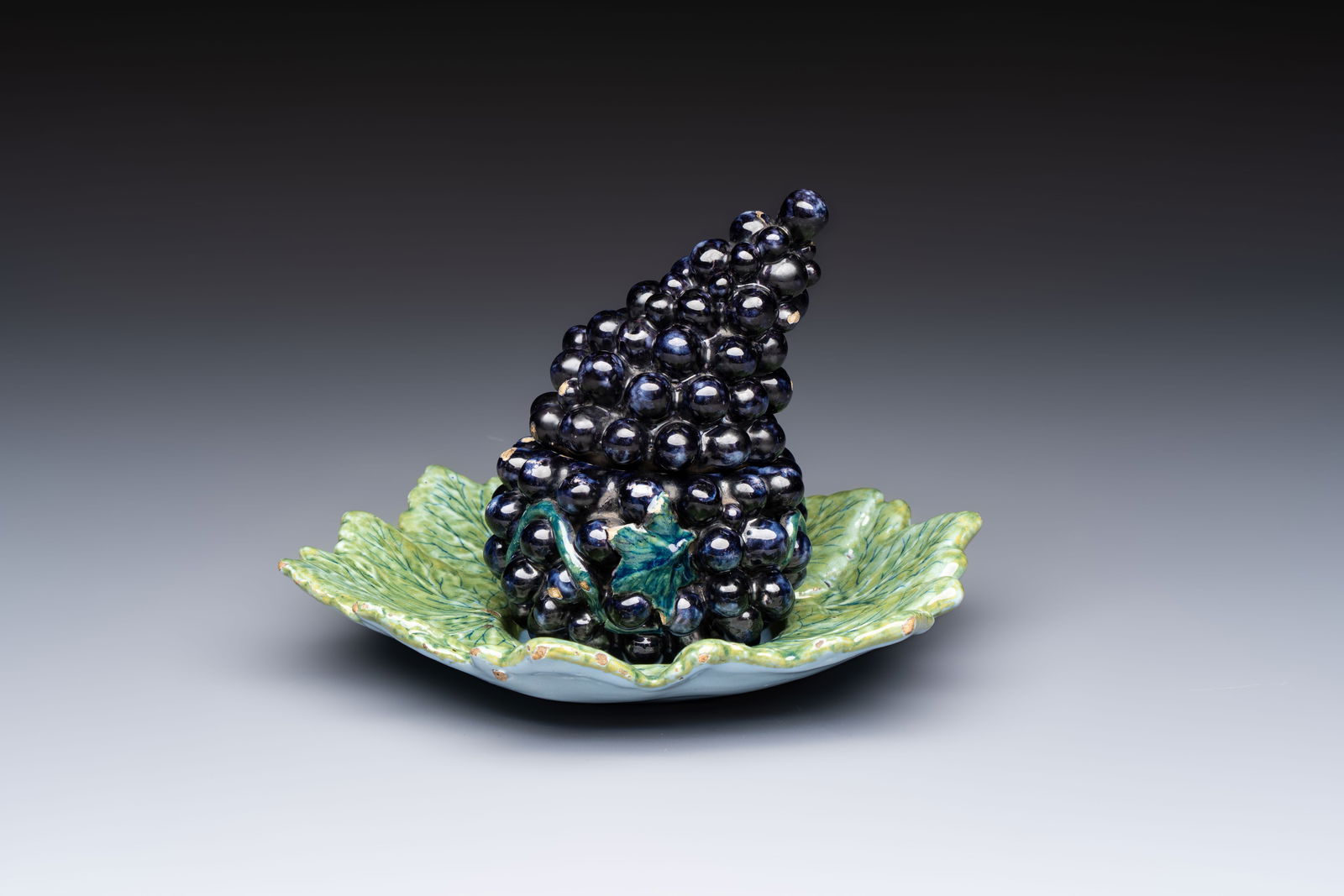 A polychrome Dutch Delft 'Bunch of Grapes' tureen and cover, 18th C. (1 of 9)