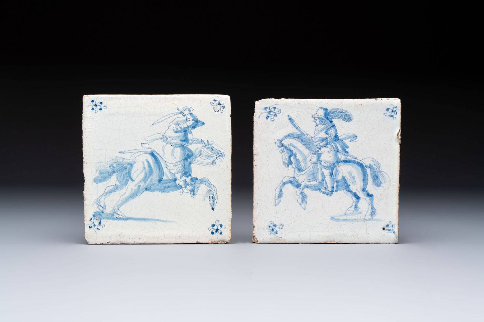 Two blue and white Dutch Delft 'Horsemen' tiles, 17th C.: Two blue and white Dutch Delft 'Horsemen' tiles, 17th C. Dim.: ca. 13 x 13 x 1,2 cm (the largest) Dim.: ca. 12,8 x 12,8 x 1,2 cm (the smallest)