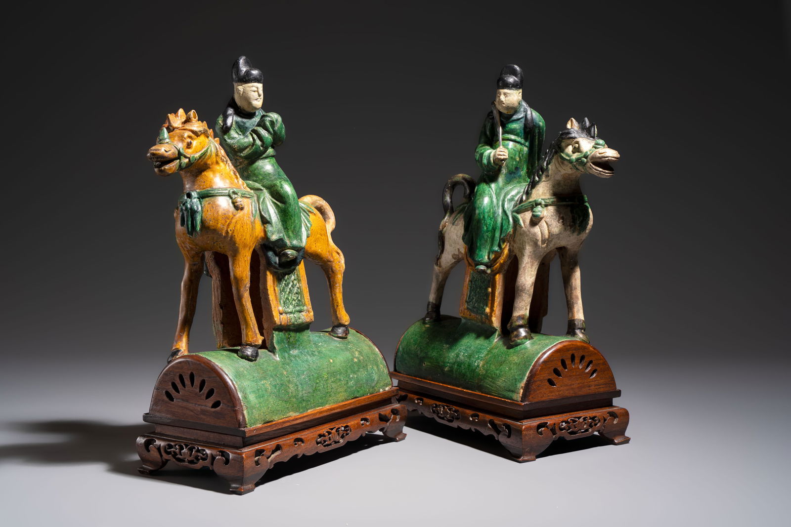 A pair of Chinese sancai-glazed 'Horseriders' roof tiles on wooden stands, Ming (1 of 8)
