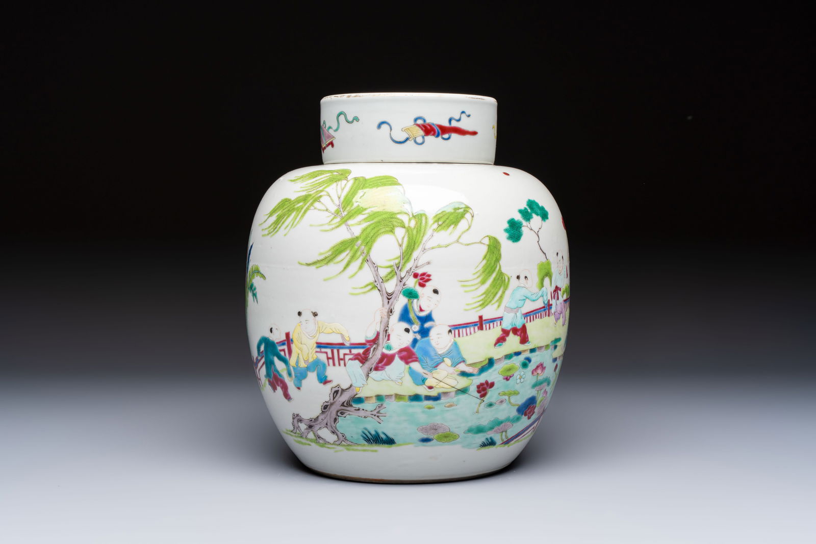 A Chinese famille rose 'Playing Boys' jar and cover, Kangxi mark, 19th C.: A Chinese famille rose 'Playing Boys' jar and cover, Kangxi mark, 19th C. H.: 23,5 cm (incl. cover)