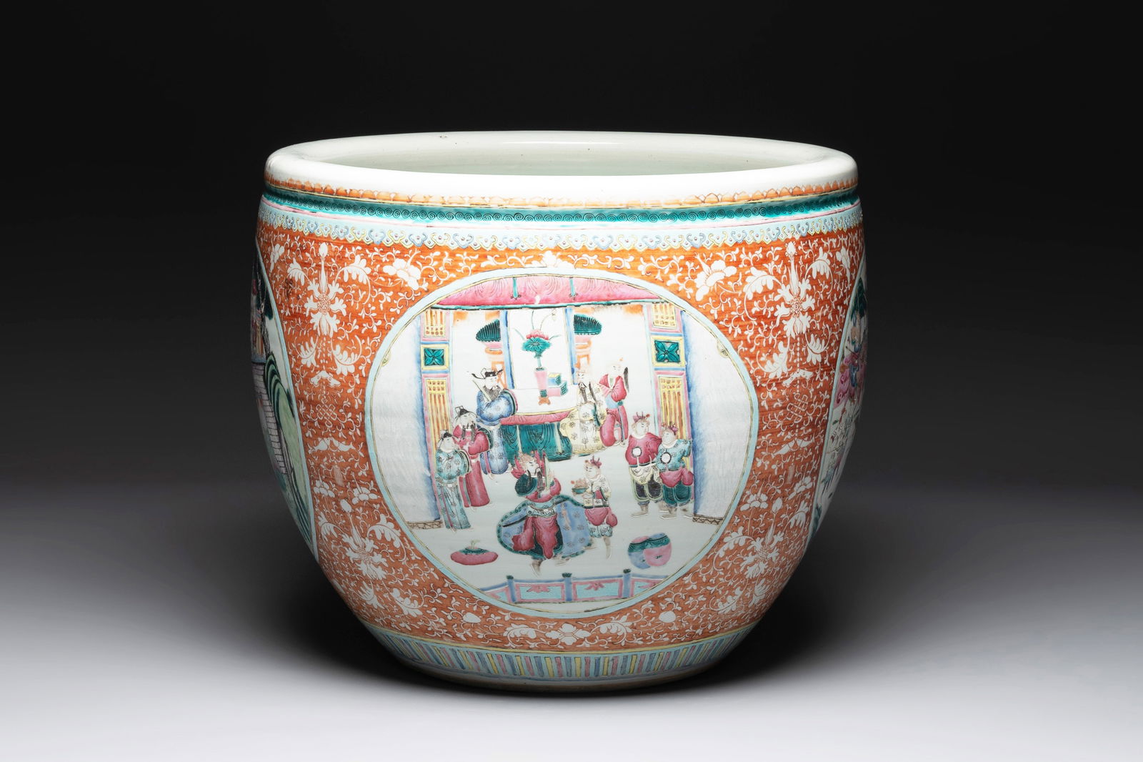 A large Chinese famille rose coral-red-ground fish bowl with narrative design, 19th C. (1 of 6)