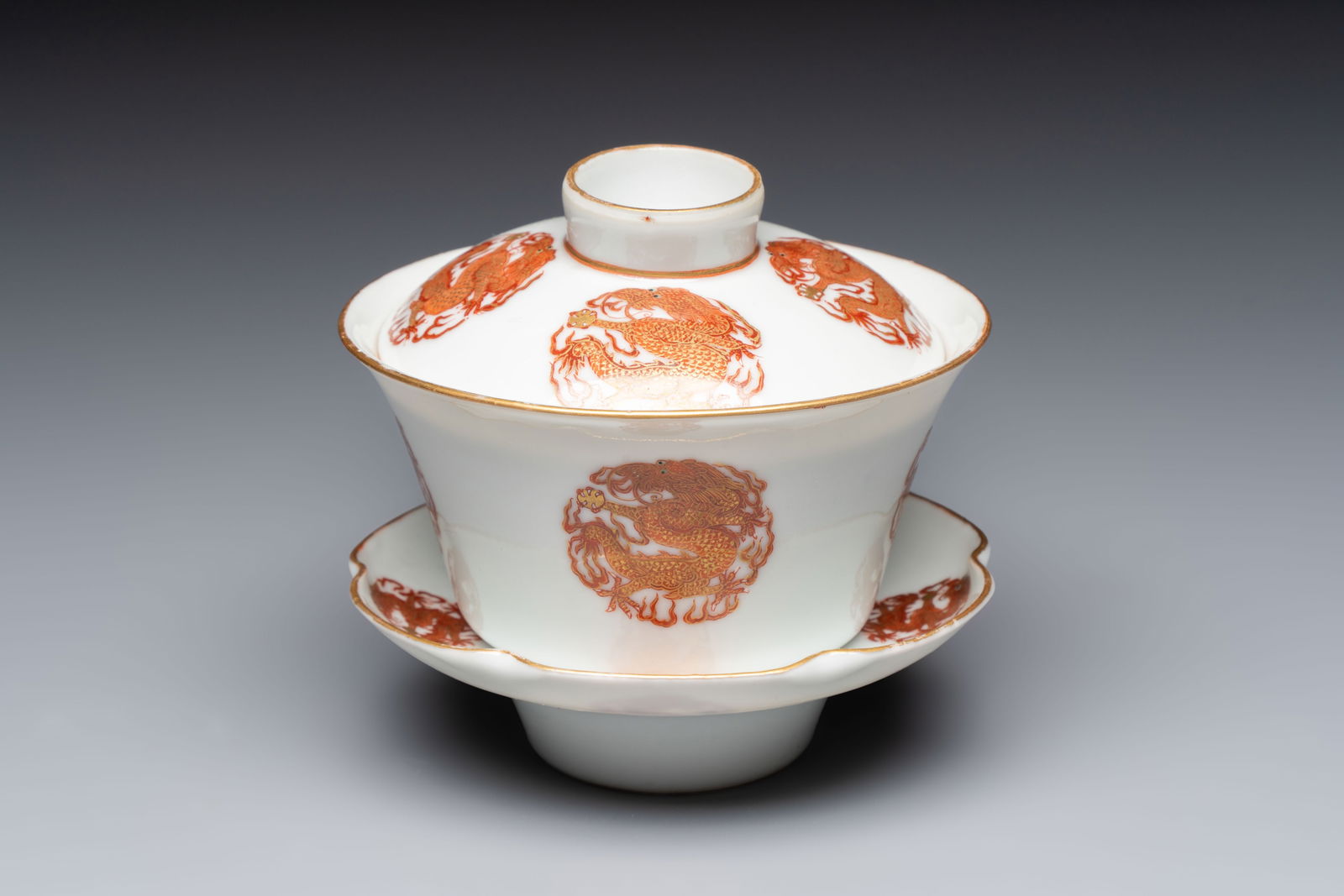 A fine Chinese iron-red gilt-decorated covered teabowl with a stand, Guangxu mark and of the period (1 of 12)