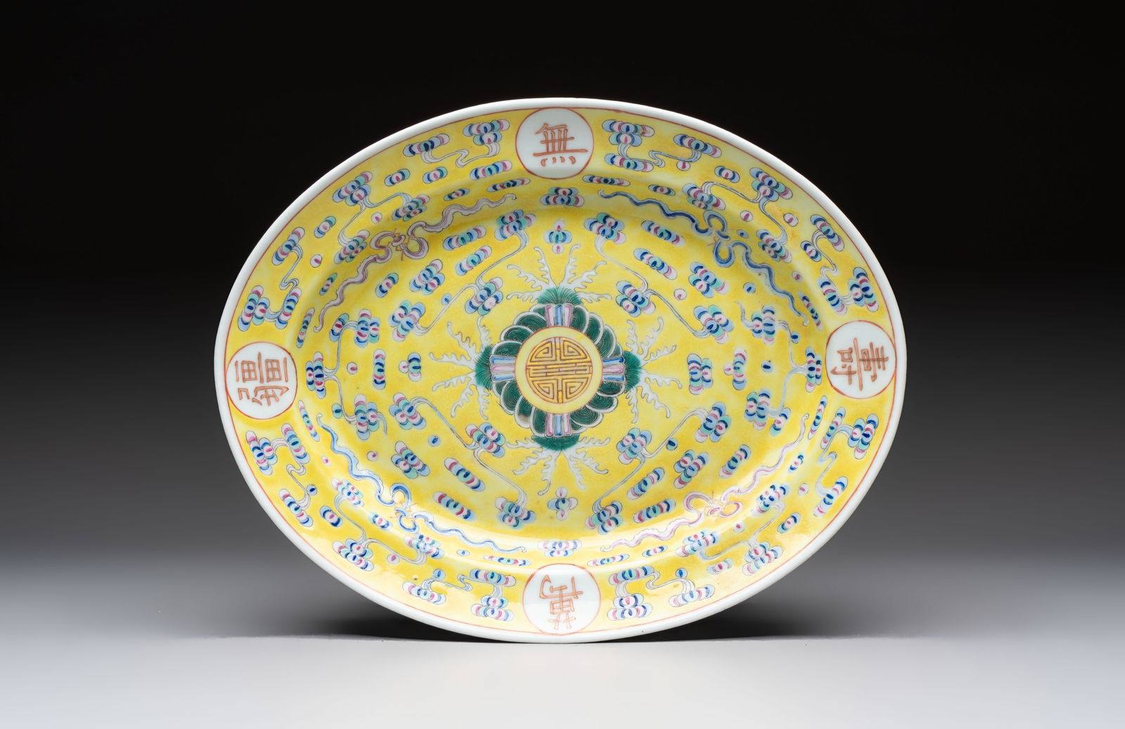 A Chinese famille rose yellow-ground footed oval 'Birthday' dish, Guangxu mark and of the period (1 of 3)