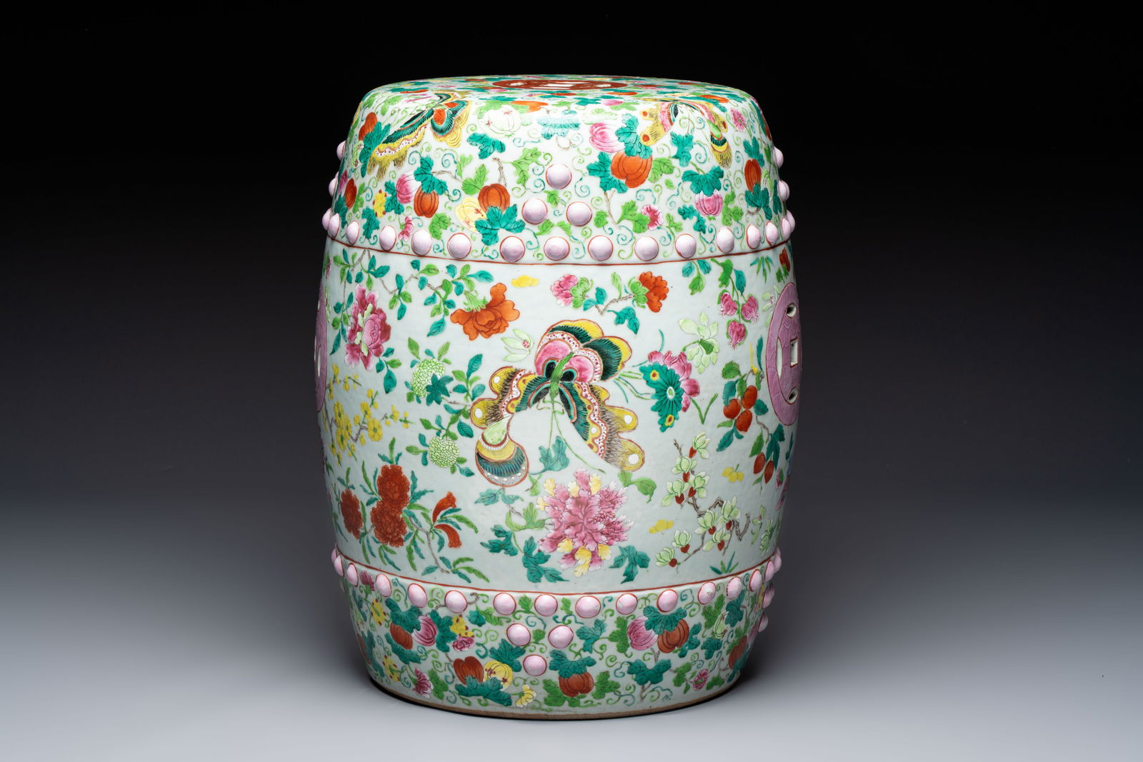 A Chinese famille rose garden seat with butterflies, flowers and fruiting branches, 19th C.: A Chinese famille rose garden seat with butterflies, flowers and fruiting branches, 19th C. H.: 46 cm