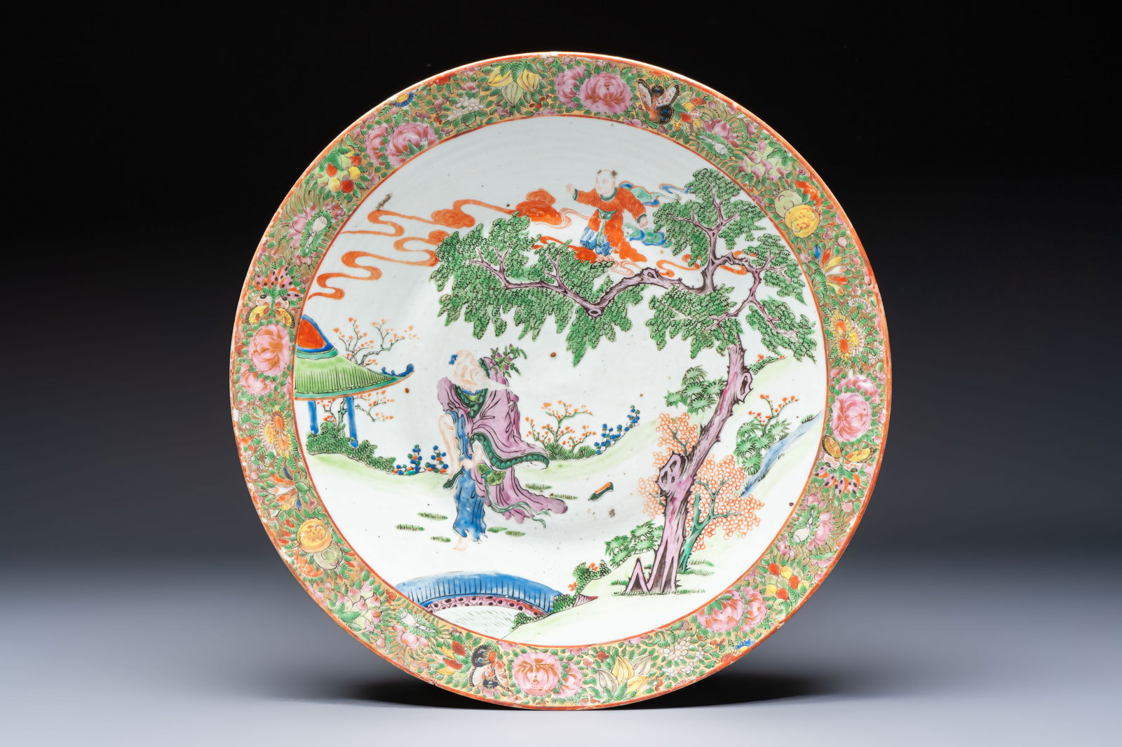 A Chinese Canton famille rose 'Dongfang Shuo Stealing Peaches' dish, 19th C. (1 of 2)