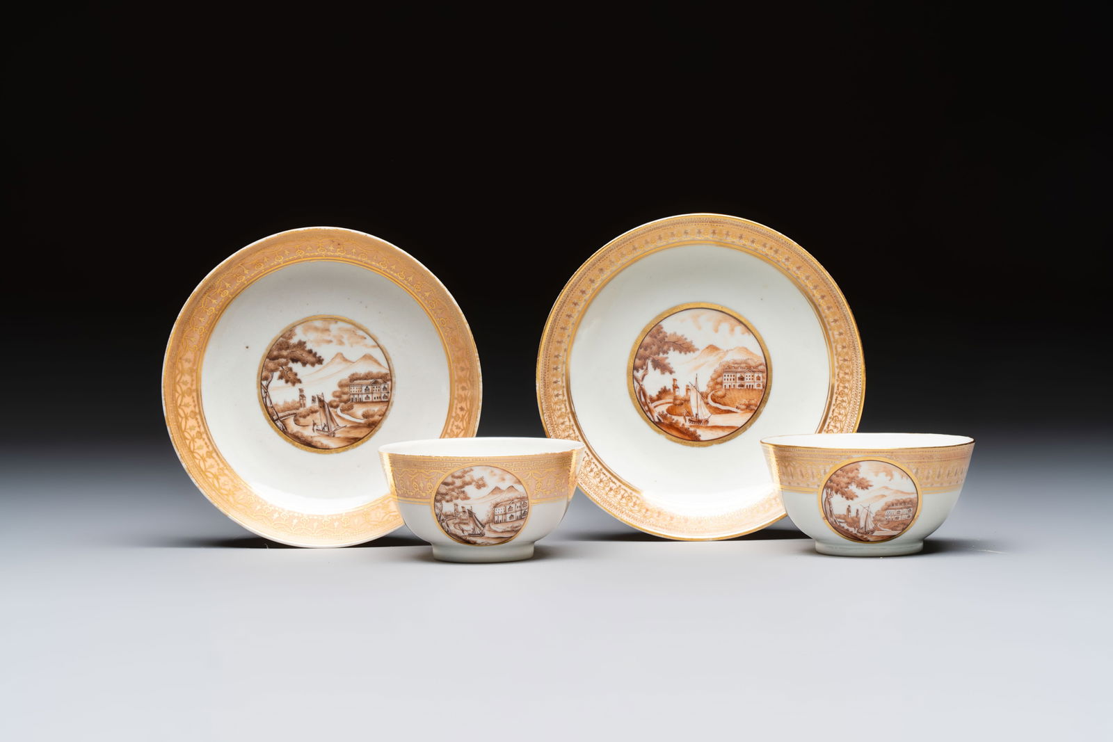 A pair of Chinese gilt-decorated sepia 'Riverscape' cups and saucers, Jiaqing (1 of 9)