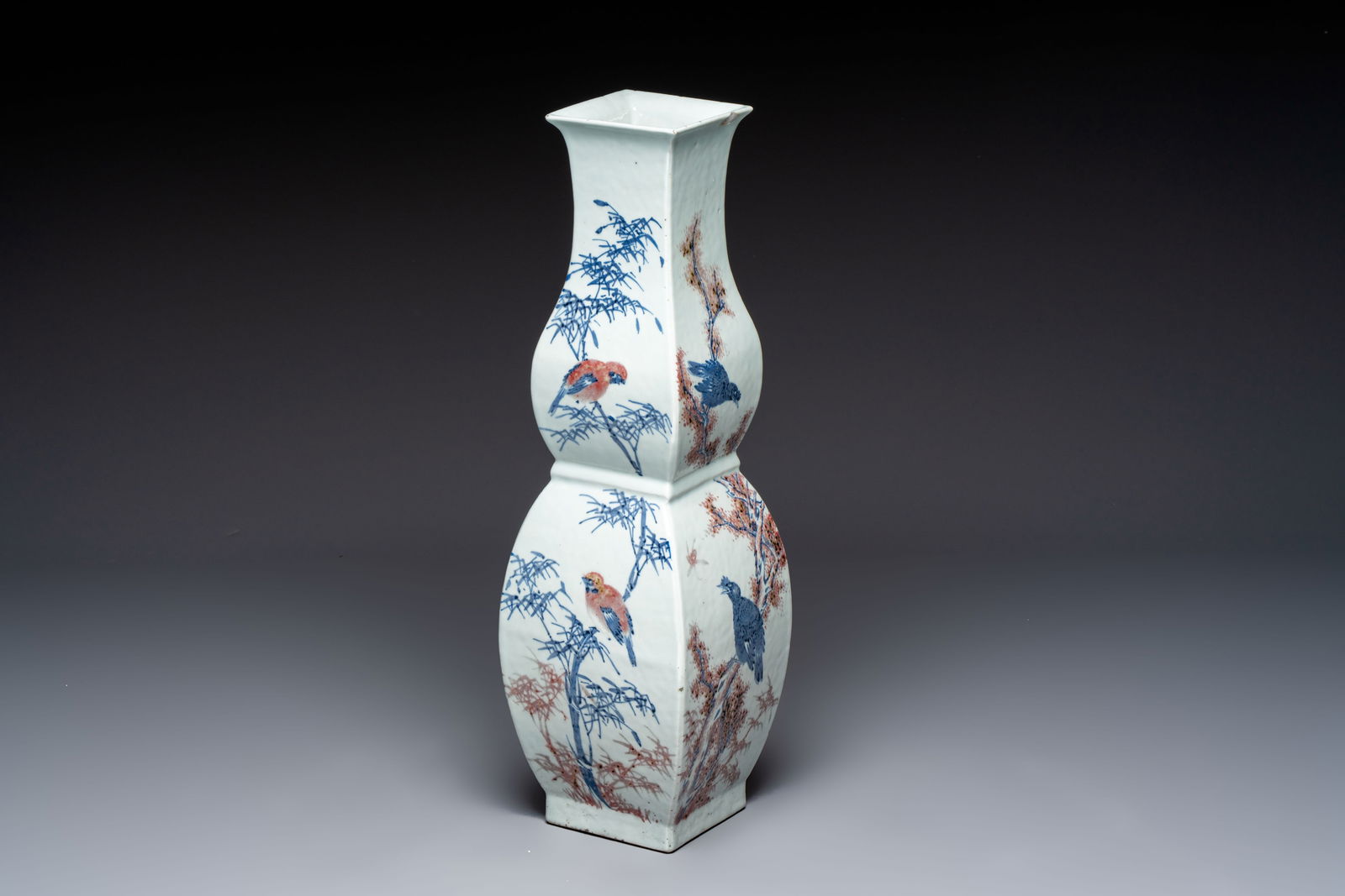 A Chinese blue, white and copper-red 'Birds among Flowering Branches' square gourd vase, 19th C.: A Chinese blue, white and copper-red 'Birds among Flowering Branches' square gourd vase, 19th C. H.: 57,5 cm