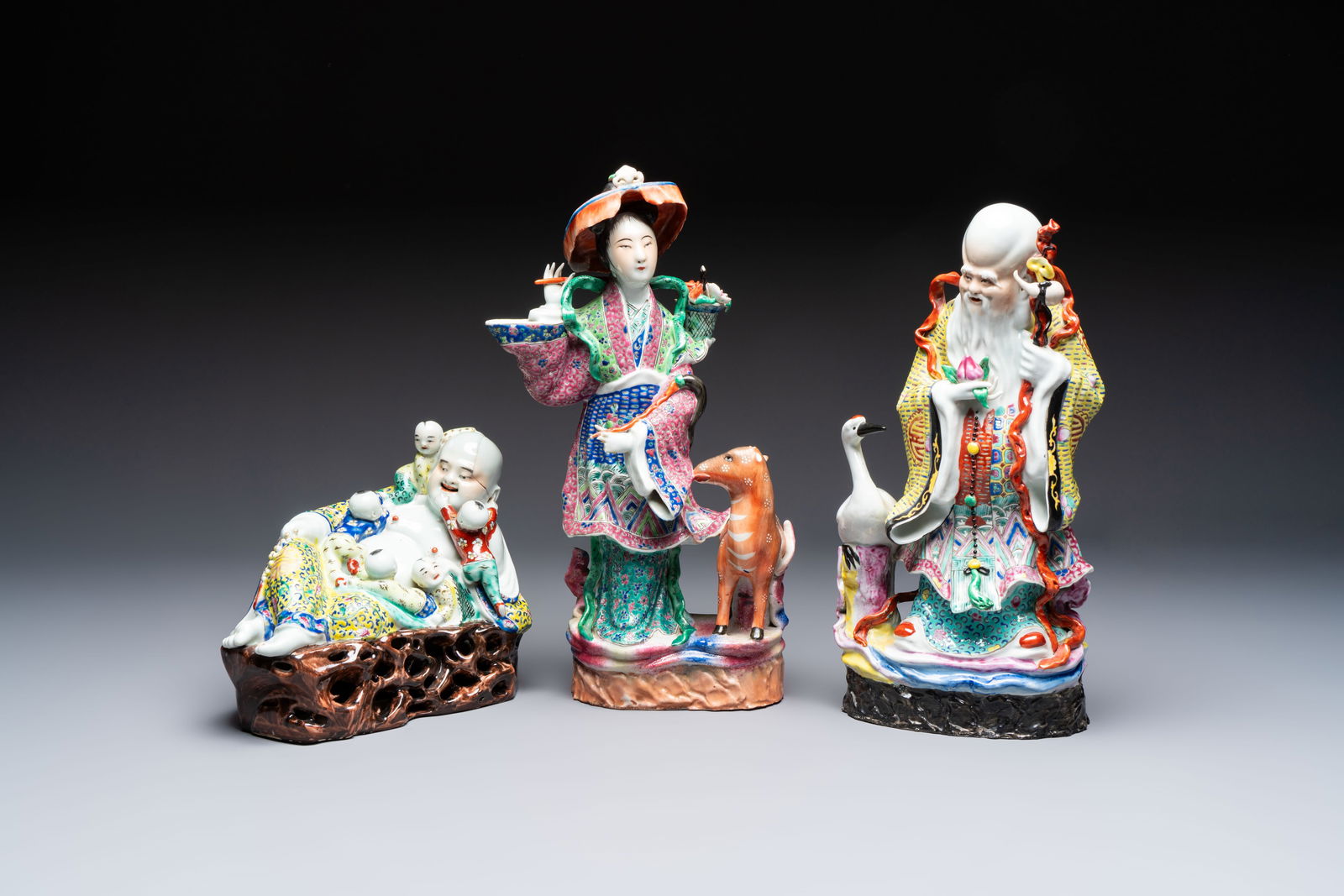 Three Chinese famille rose 'Milefo Buddha', 'Magu' and 'Shoulao' groups, 19/20th C. (1 of 7)