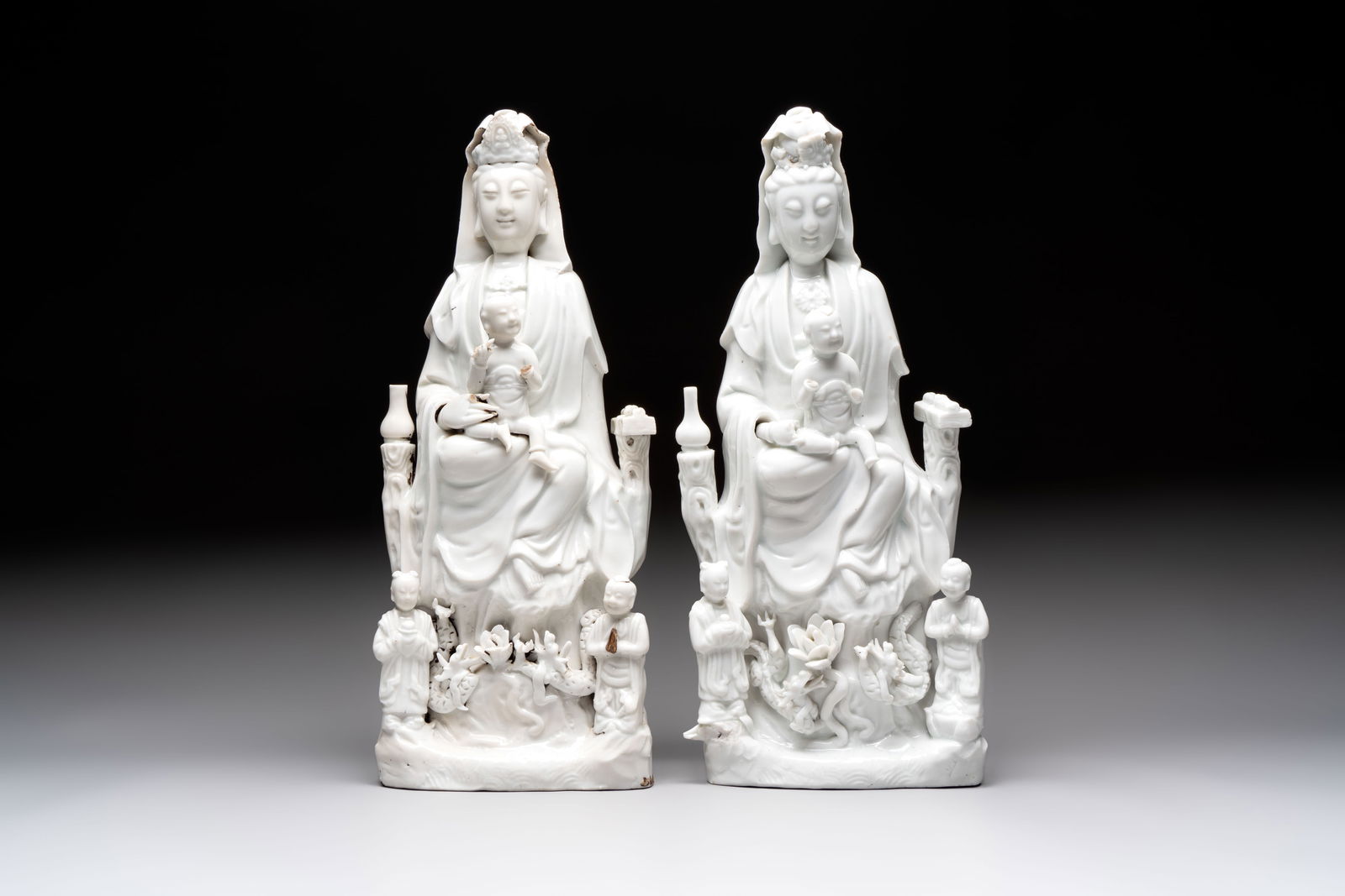 A pair of Chinese Dehua blanc de Chine groups of Guanyin with a child and servants, 18th C. (1 of 7)