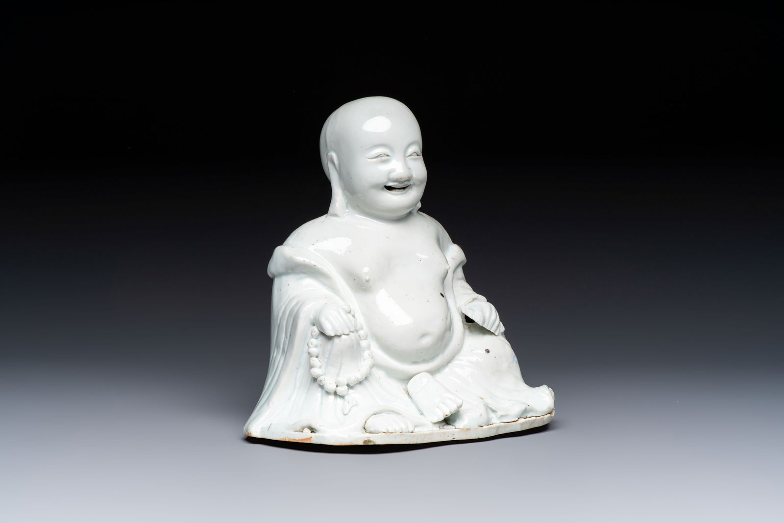 A Chinese white-glazed Milefo Buddha, 19th C. (1 of 7)