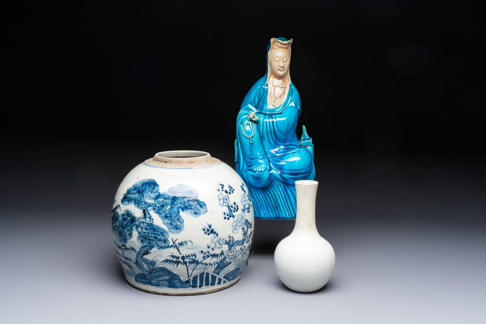 A Chinese turquoise-glazed Guanyin, a white-glazed bottle vase and a blue and white jar, 19th C. (1 of 13)