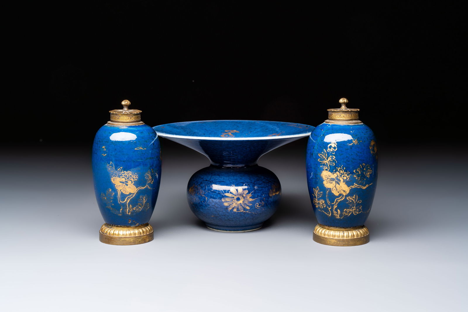 A Chinese powder-blue-ground gilt-decorated spittoon and two gilt-bronze-mounted vases, 18th C. (1 of 13)