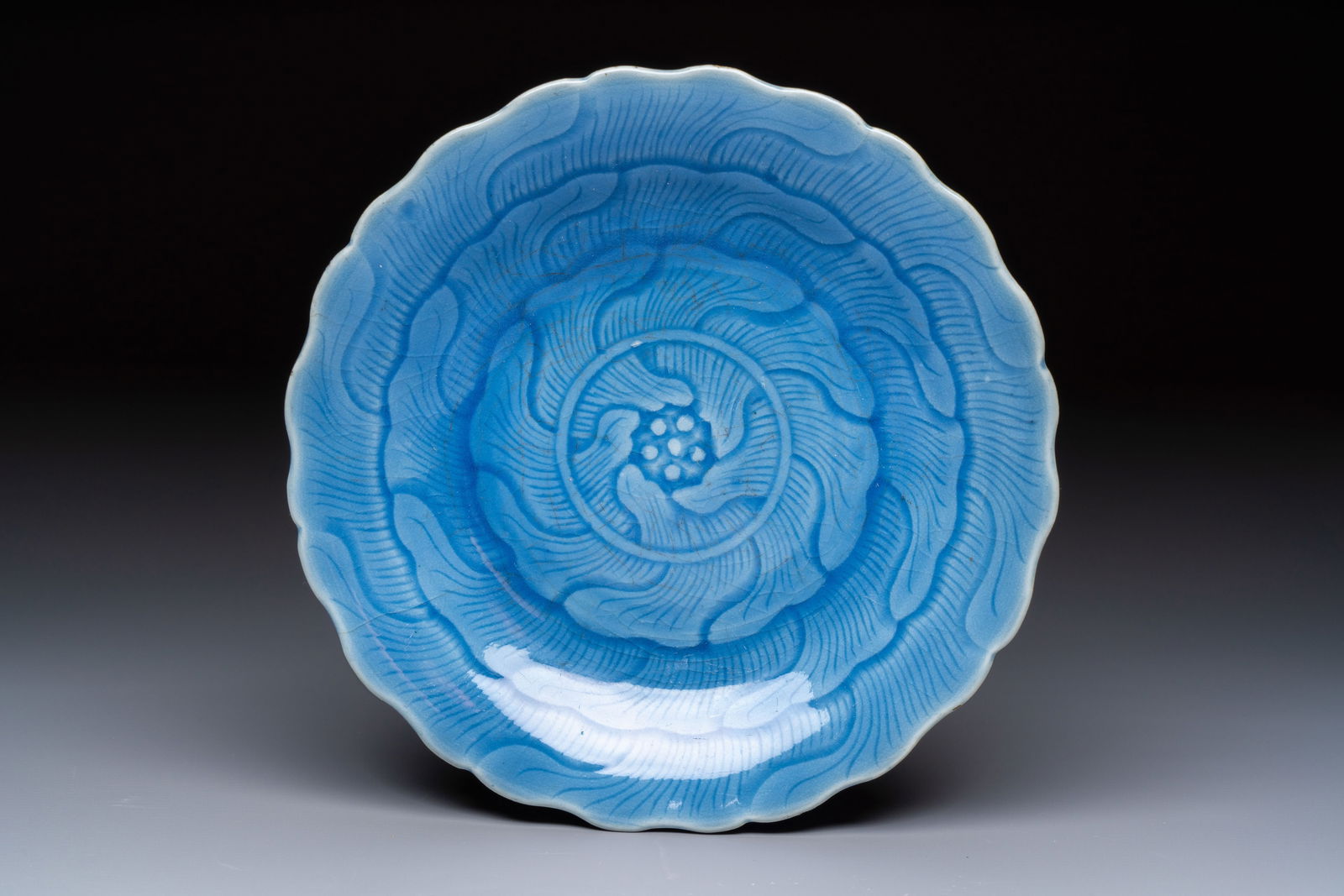 A Chinese blue-glazed 'Lotus' plate, Qianlong mark and of the period (1 of 2)