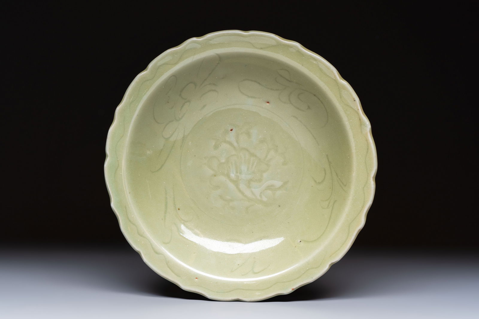 A Chinese Longquan celadon plate with incised floral design, Ming (1 of 2)