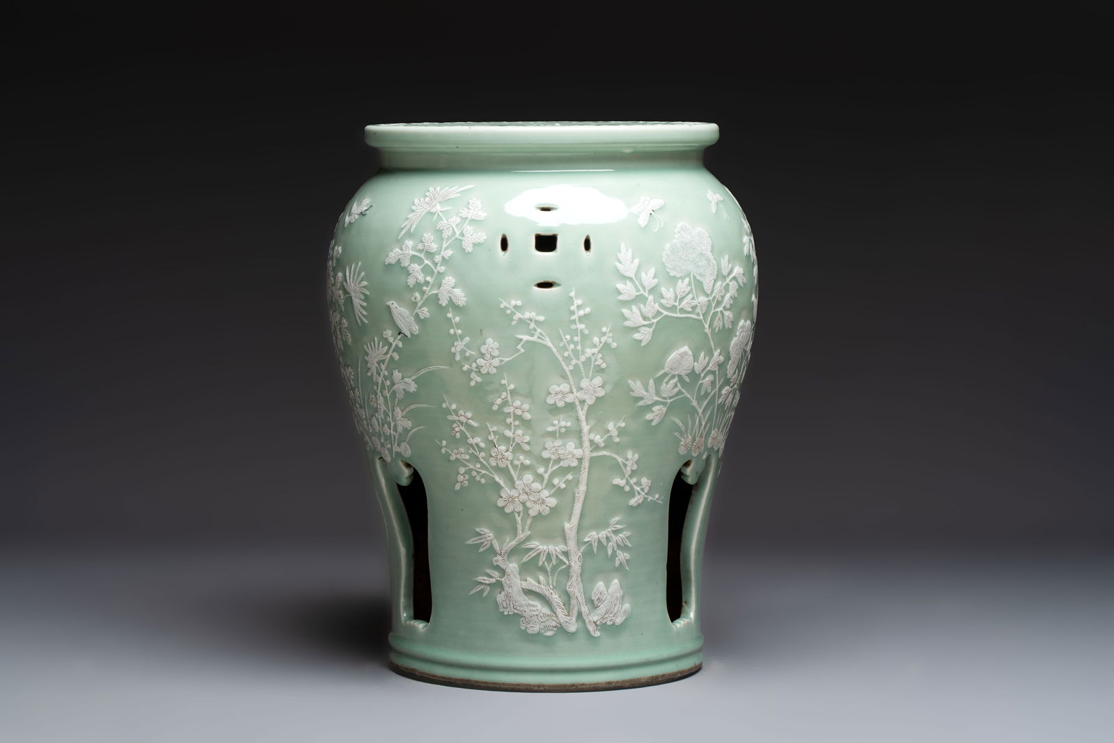 A Chinese slib-decorated celadon-ground garden seat, 19th C. (1 of 7)