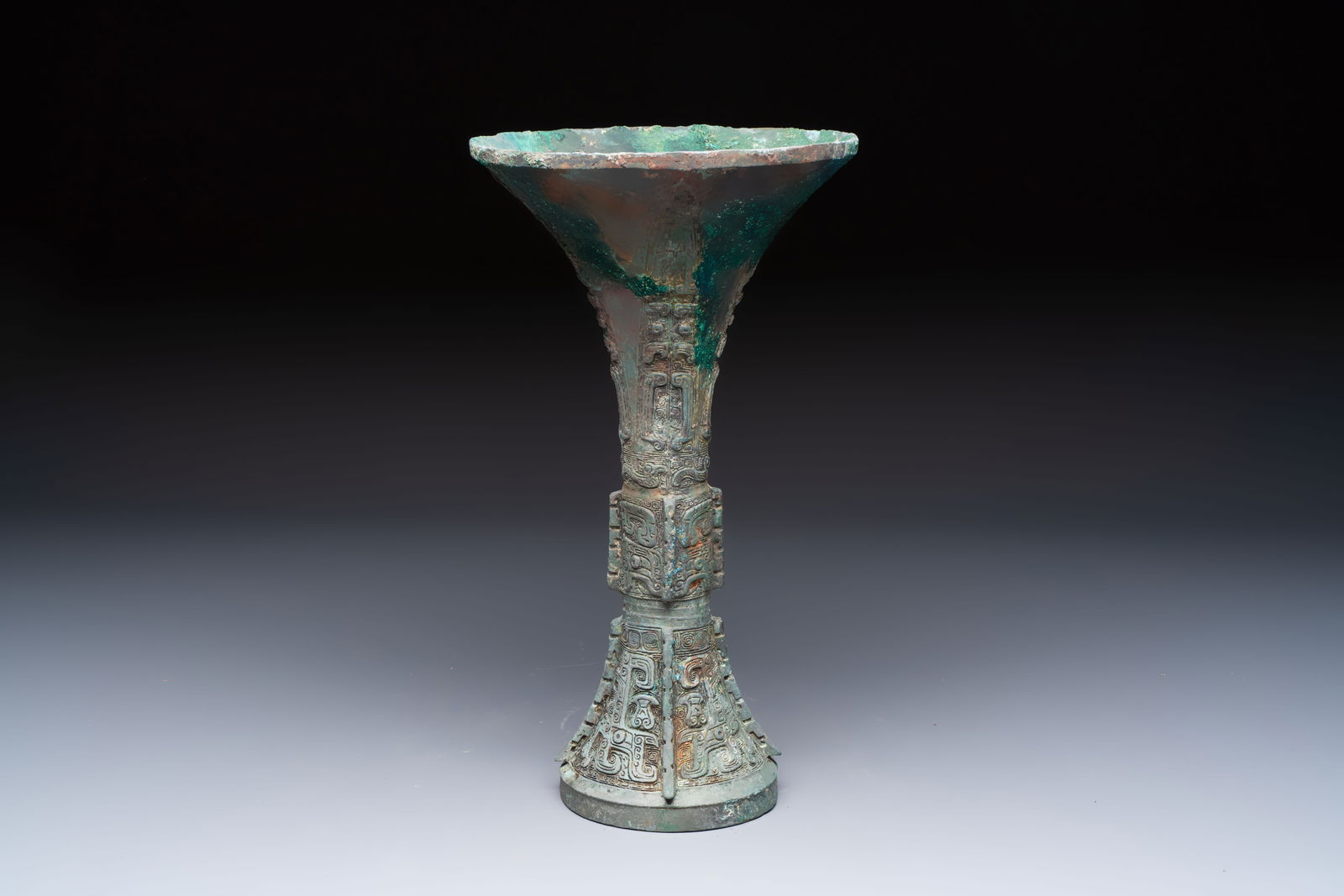 A Chinese archaic bronze wine vessel with Taotie design, Gu, Shang (1 of 6)