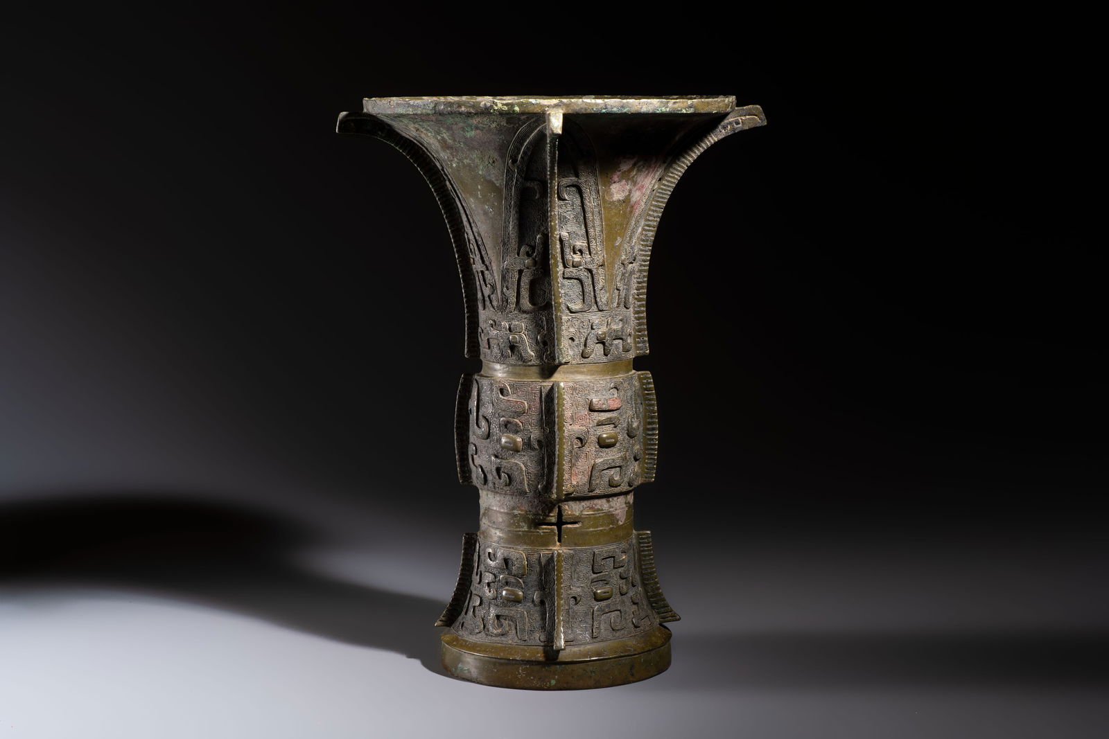 A Chinese archaic bronze wine vessel with Taotie design, Zun, late Shang (1 of 6)