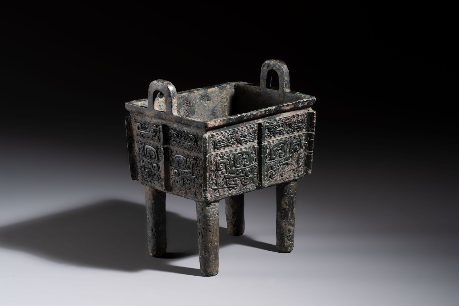 An inscribed Chinese archaic bronze food vessel with Taotie design, Ding, Western Zhou (1 of 8)