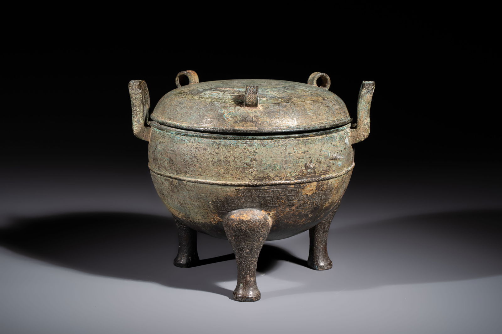 A Chinese archaic bronze tripod food vessel and cover, Ding, Eastern Zhou (1 of 7)
