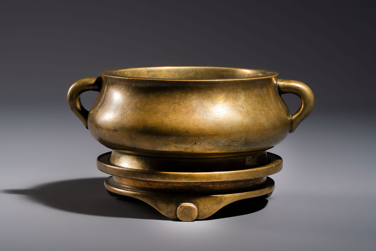 A fine Chinese bronze censer with loop handles and stand, Xuande mark, 18th C. (1 of 7)
