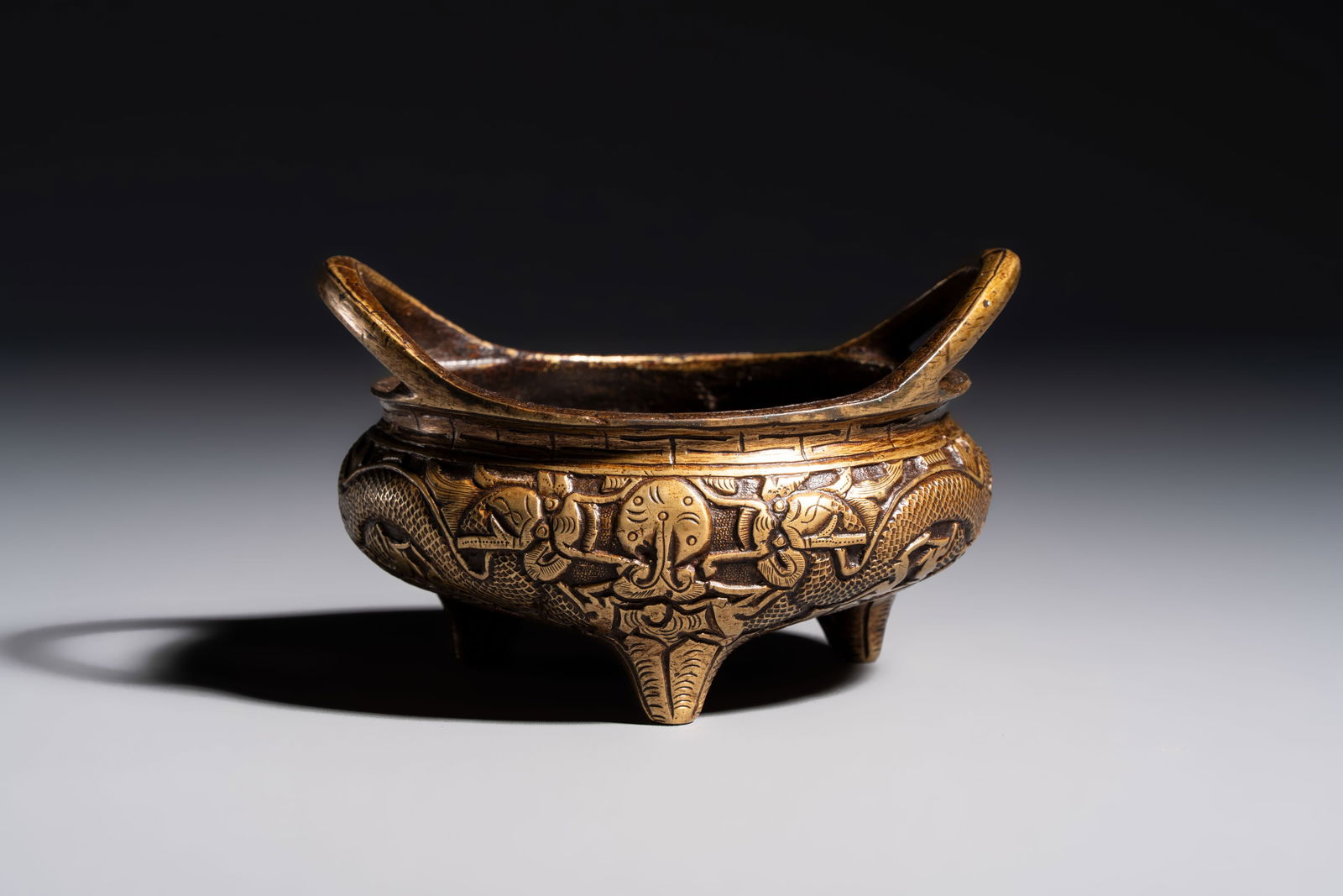 A Chinese bronze tripod 'Dragon' censer with two handles, Xuande mark, 19th C. (1 of 7)