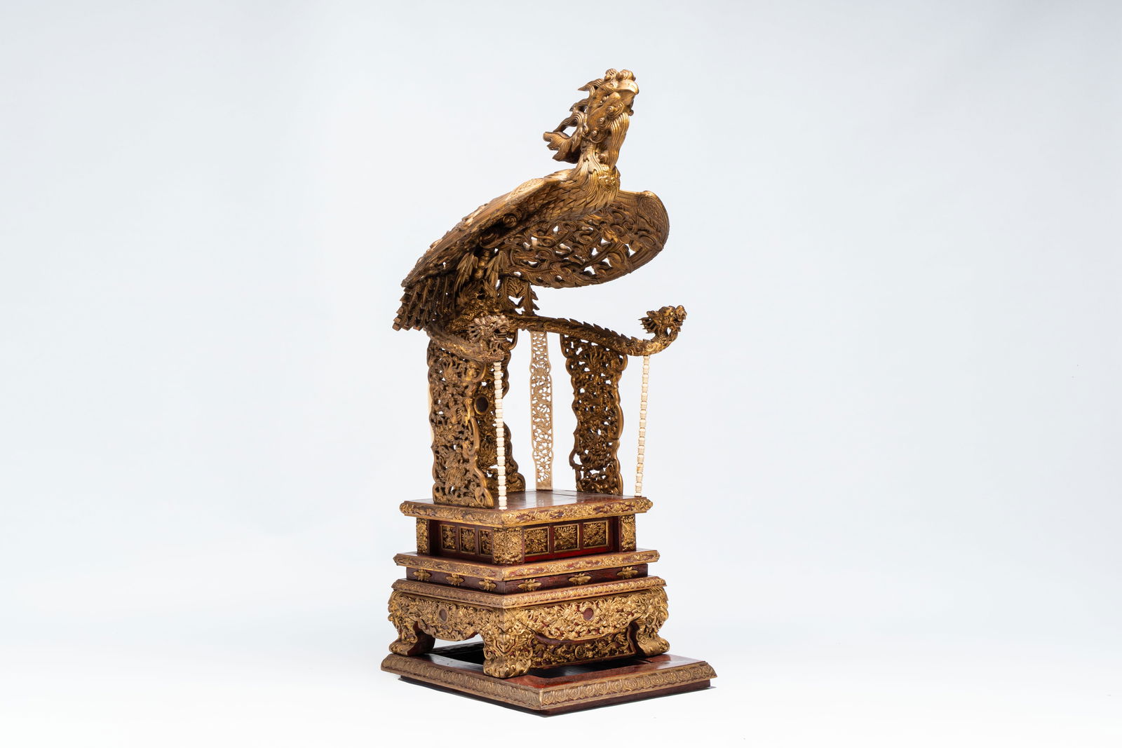 An exceptional Vietnamese gilt-lacquered wood and ivory 'Dragon and Phoenix' throne-shaped altar, (1 of 19)