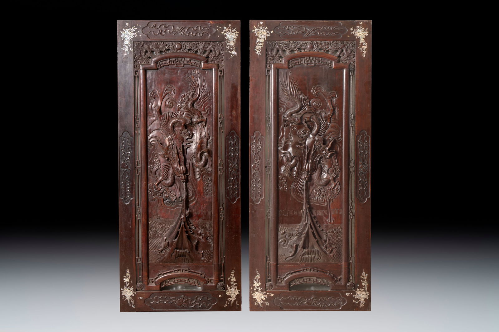 A pair of Vietnamese mother-of-pearl-inlaid hardwood 'Dragon and Carps' panels, 19th C.: A pair of Vietnamese mother-of-pearl-inlaid hardwood 'Dragon and Carps' panels, 19th C. Dim.: 88 x 4 x 210 cm