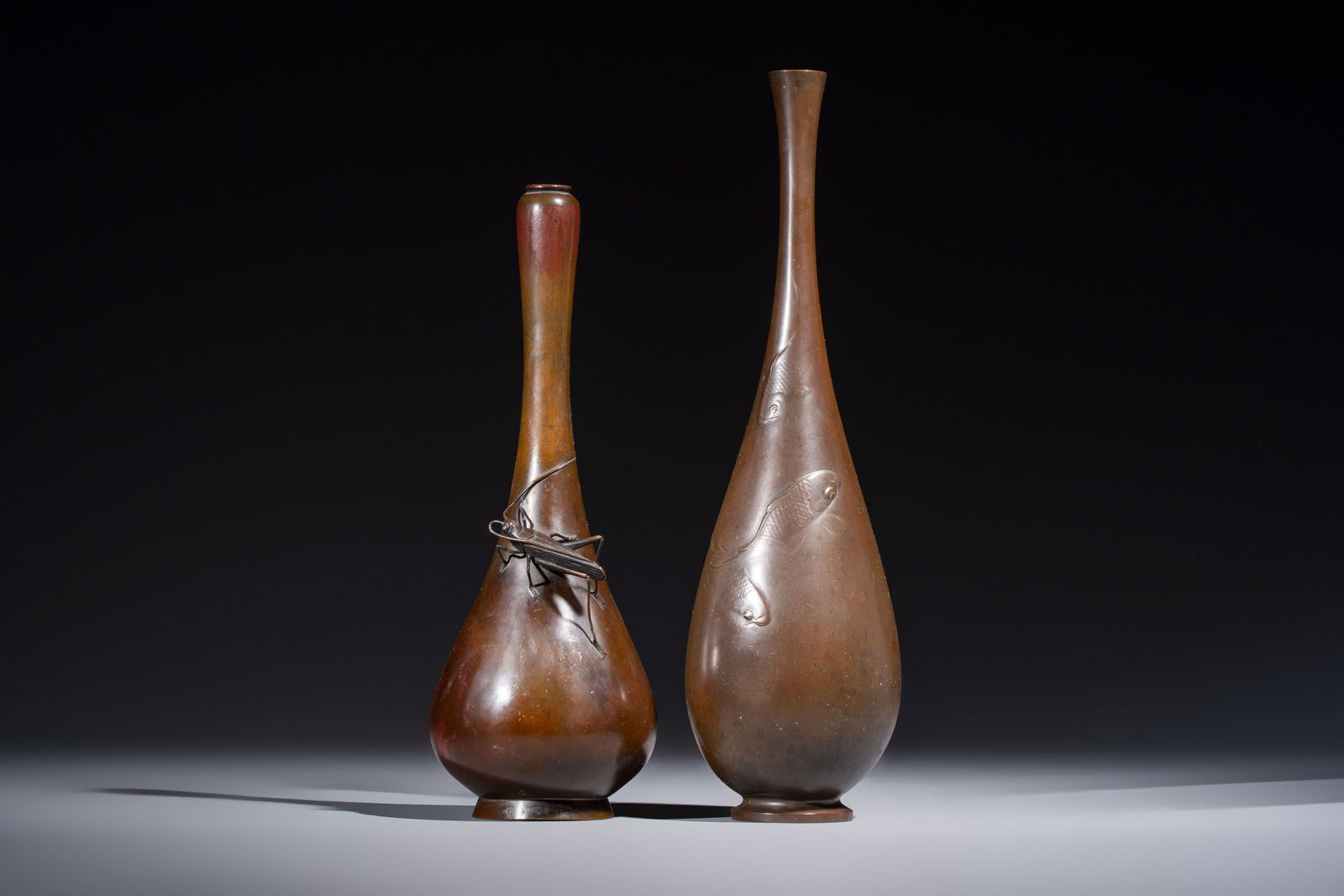 A Japanese bronze 'Koi' vase and a 'Cricket' vase, 19/20th C.: A Japanese bronze 'Koi' vase and a 'Cricket' vase, 19/20th C. H.: 31,7 cm (the tallest) H.: 27 cm (the smallest) Weight: - 1057 grams (the tallest) - 568 grams (the smallest)