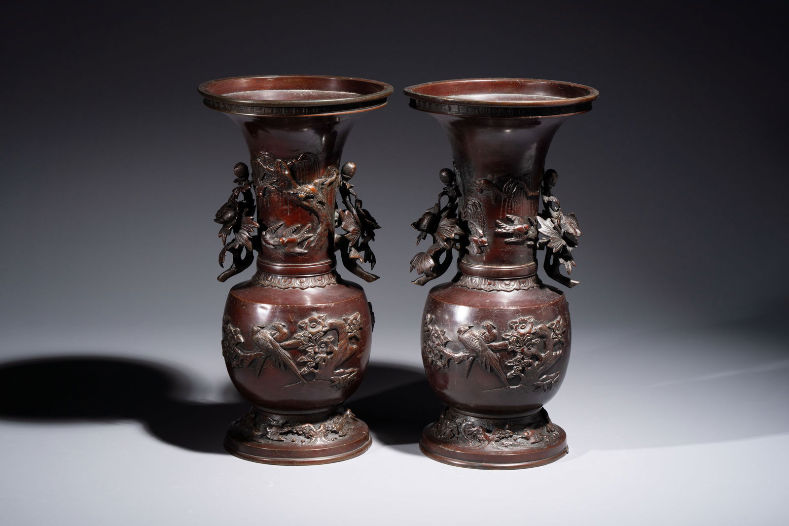 A pair of Japanese bronze vases with relief design of birds among flowering branches, signed (1 of 7)