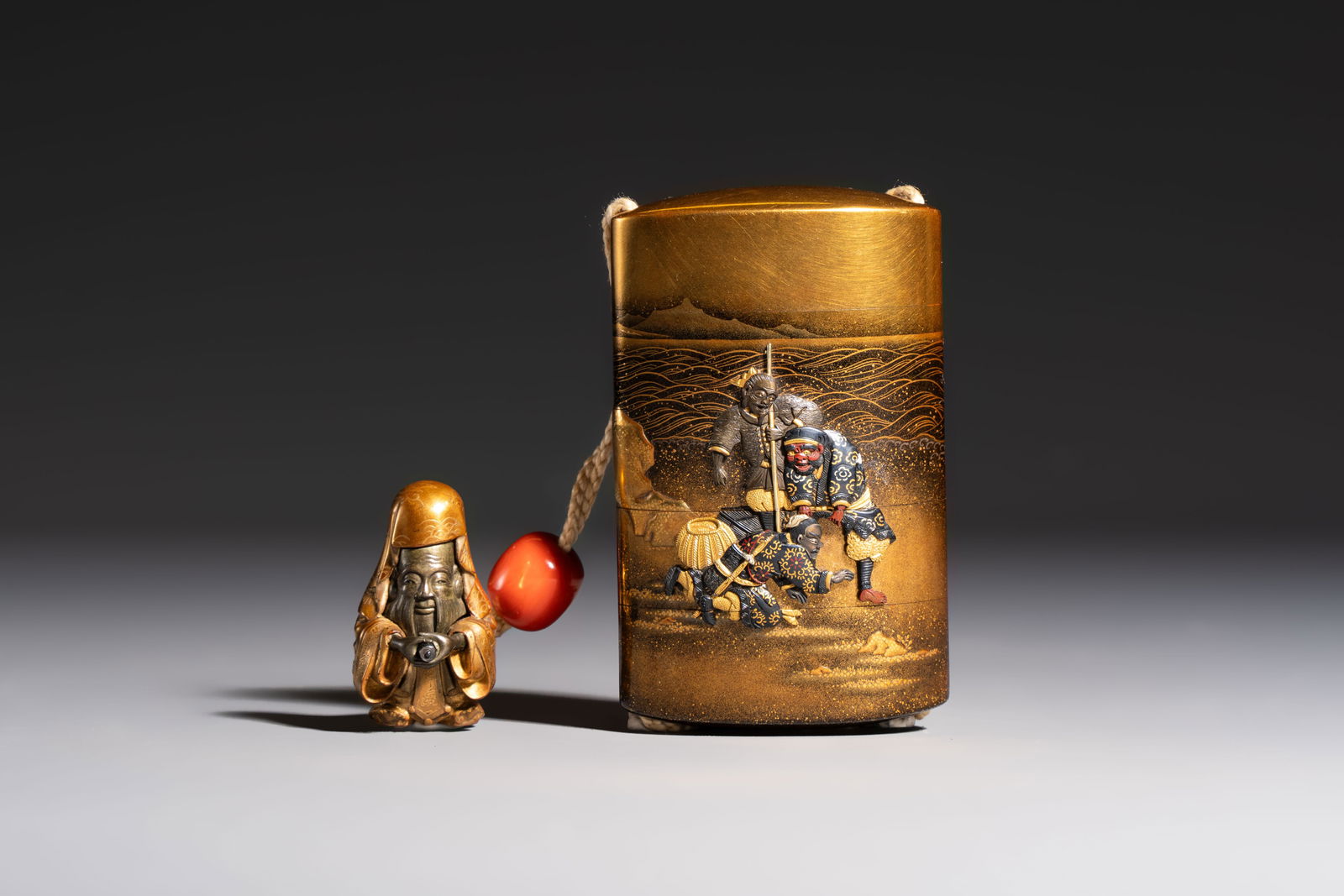 A fine Japanese four-case metal-inlaid lacquer 'Kanshin' inro by Kozan with a red coral ojime and a (1 of 9)