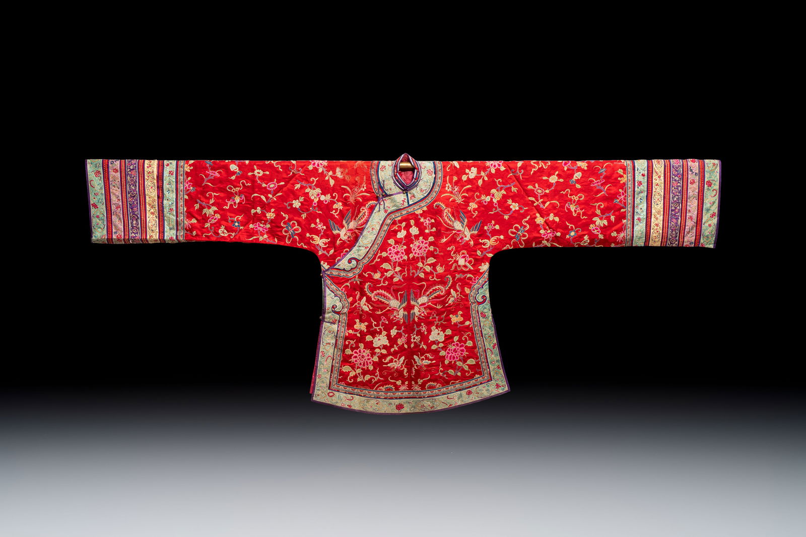A Chinese embroidered silk red-ground women's robe, 19th C. (1 of 6)