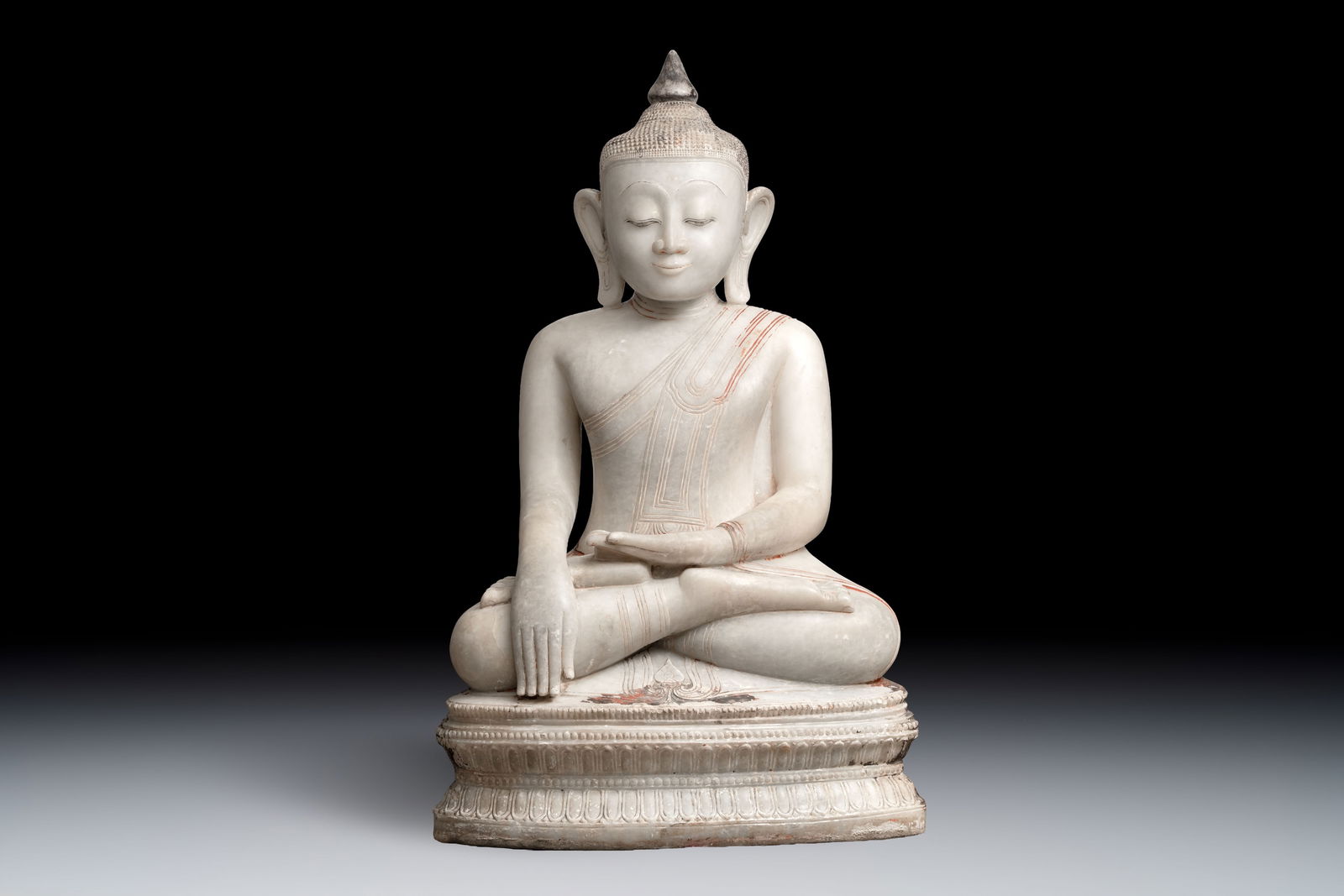 A monumental Burmese white marble Post-Pagan Buddha with traces of gilt-lacquer, Ava Kingdom, 17th C: A monumental Burmese white marble Post-Pagan Buddha with traces of gilt-lacquer, Ava Kingdom, 17th C Dim.: 67,5 x 40 x 114 cm (the buddha) Dim.: 74 x 51 x 88,5 cm (the stand) Provenance: An important
