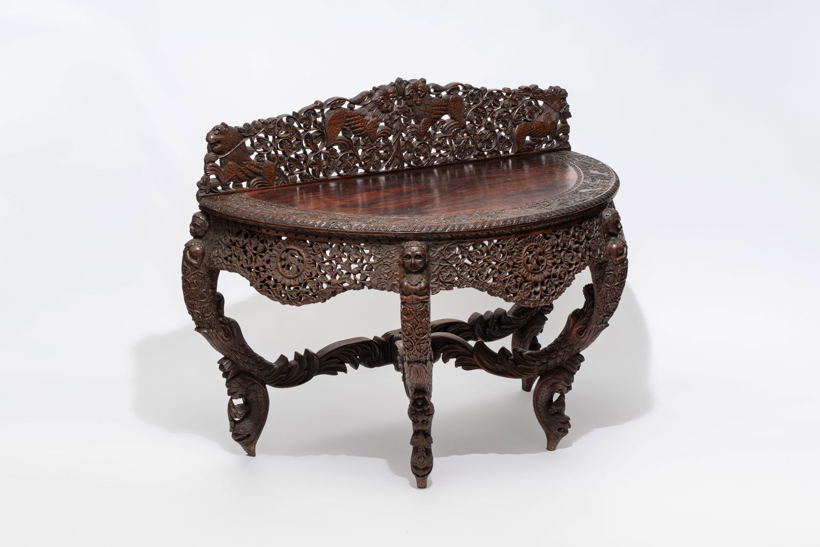 A finely carved Anglo-Indian rosewood demi-lune console table with lions, 19th C. (1 of 11)