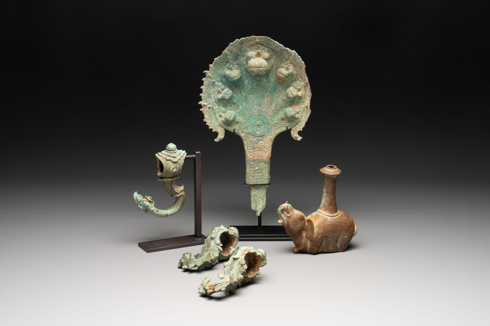 Three palanquin hooks, a bronze sculpture of naga Mucalinda and an elephant-form kendi, Cambodia, (1 of 12)