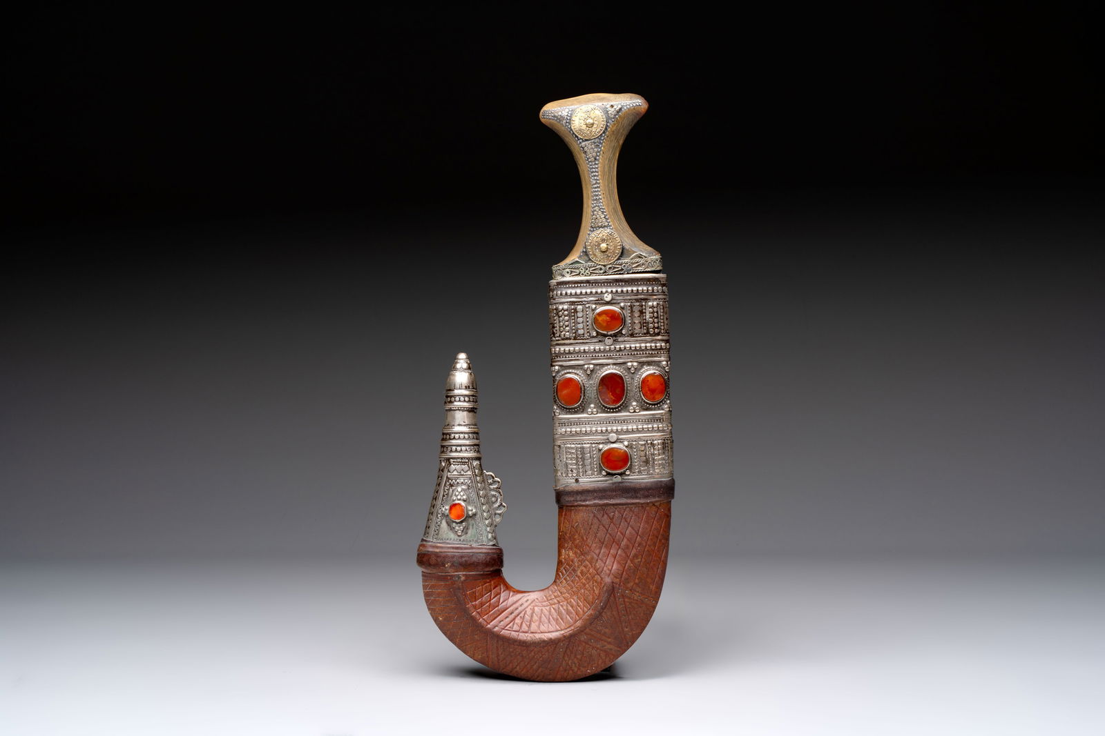 A jambiya-style dagger or 'Asib' with a horn hilt, a scabbard and silver-plated mounts, Yemen, 19th (1 of 5)