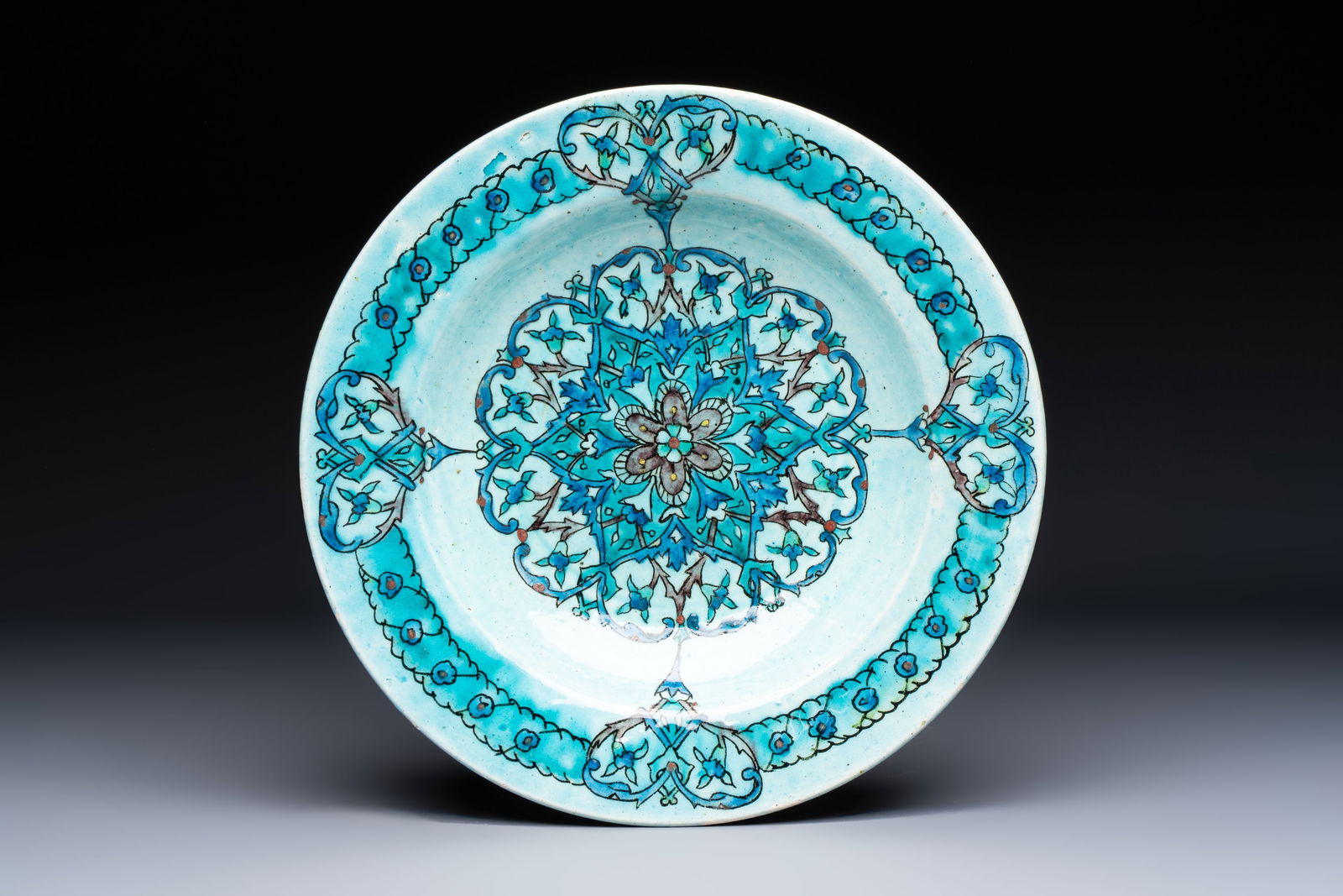 A polychrome Kuthaya pottery Iznik-style turquoise-ground dish, 19th C. (1 of 2)