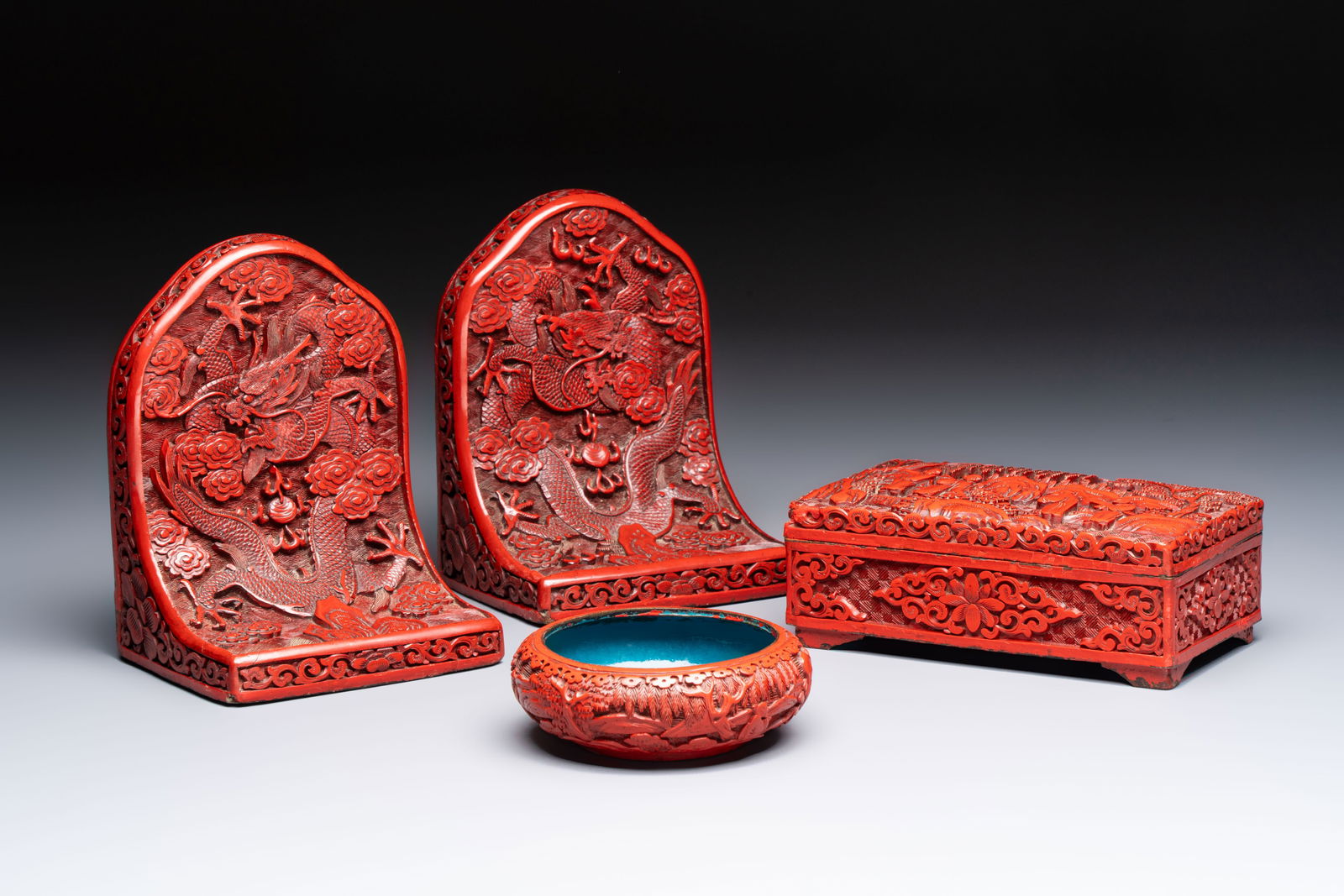 A pair of Chinese cinnabar lacquer bookends, a covered box and a brush washer, 19/20th C. (1 of 14)
