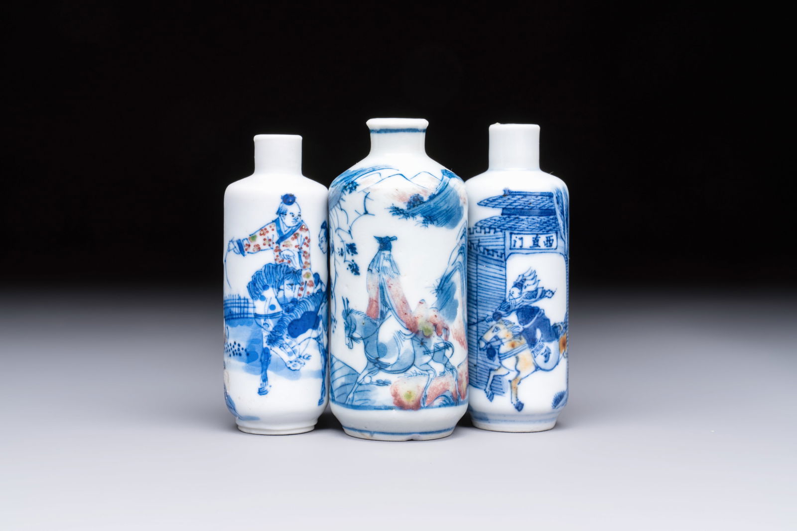 Three Chinese blue, white and copper-red snuff bottles with narrative design, 19th C. (1 of 7)