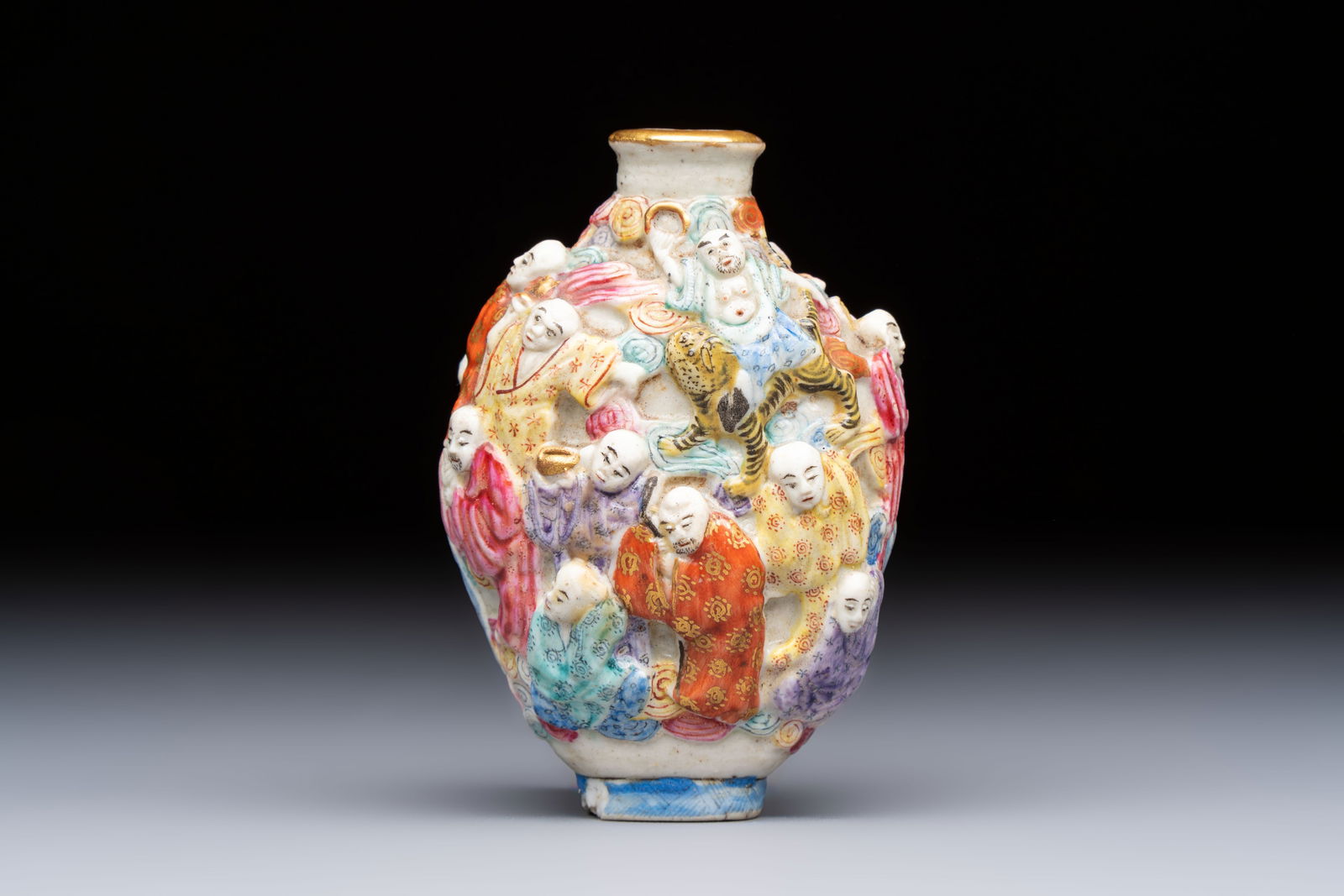 A Chinese famille rose moulded '18 Luohan' snuff bottle, Qianlong mark, 19th C.: A Chinese famille rose moulded '18 Luohan' snuff bottle, Qianlong mark, 19th C. H.: 7,8 cm