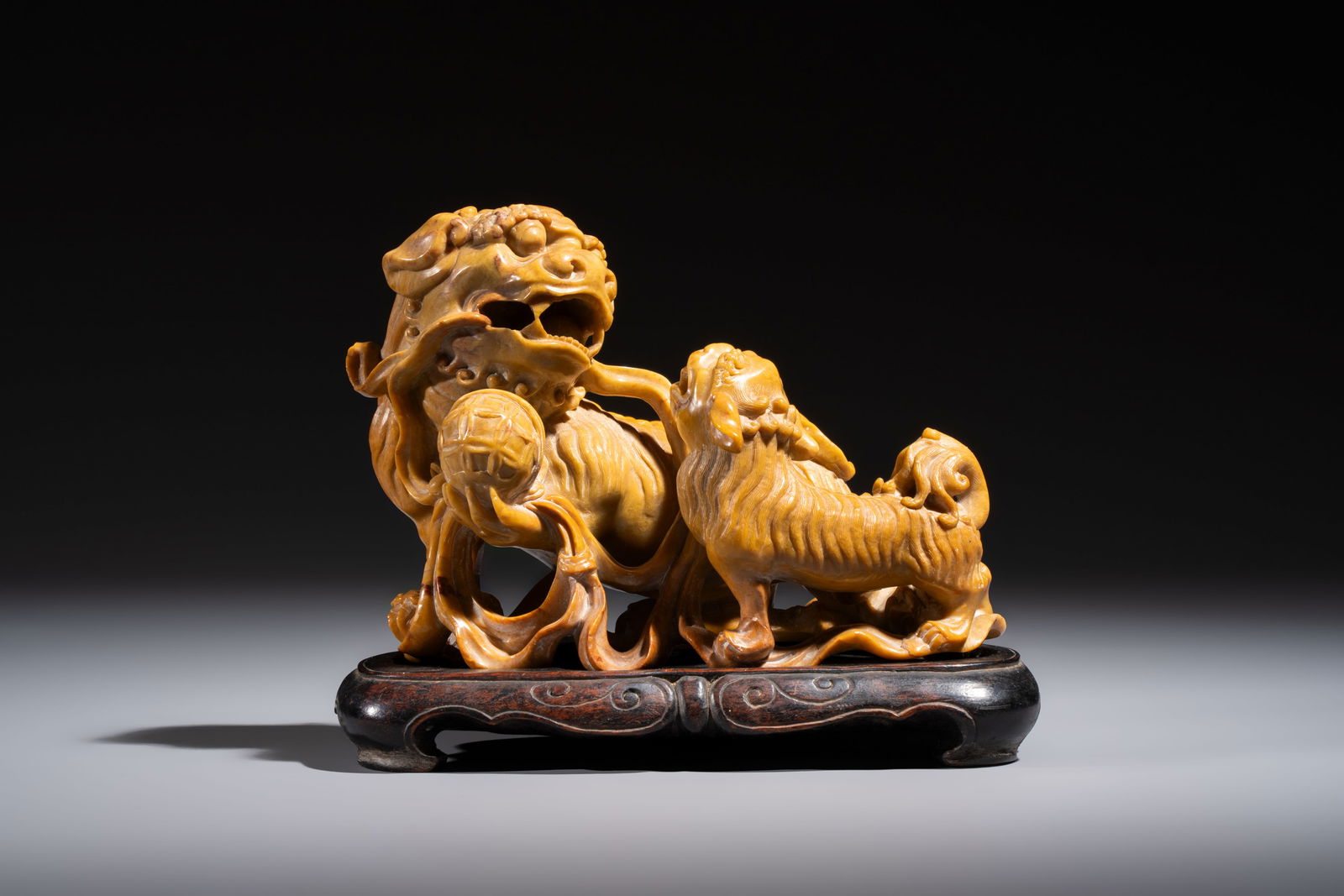 A fine Chinese soapstone group of Buddhist lions on wooden stand, 19th C. (1 of 8)