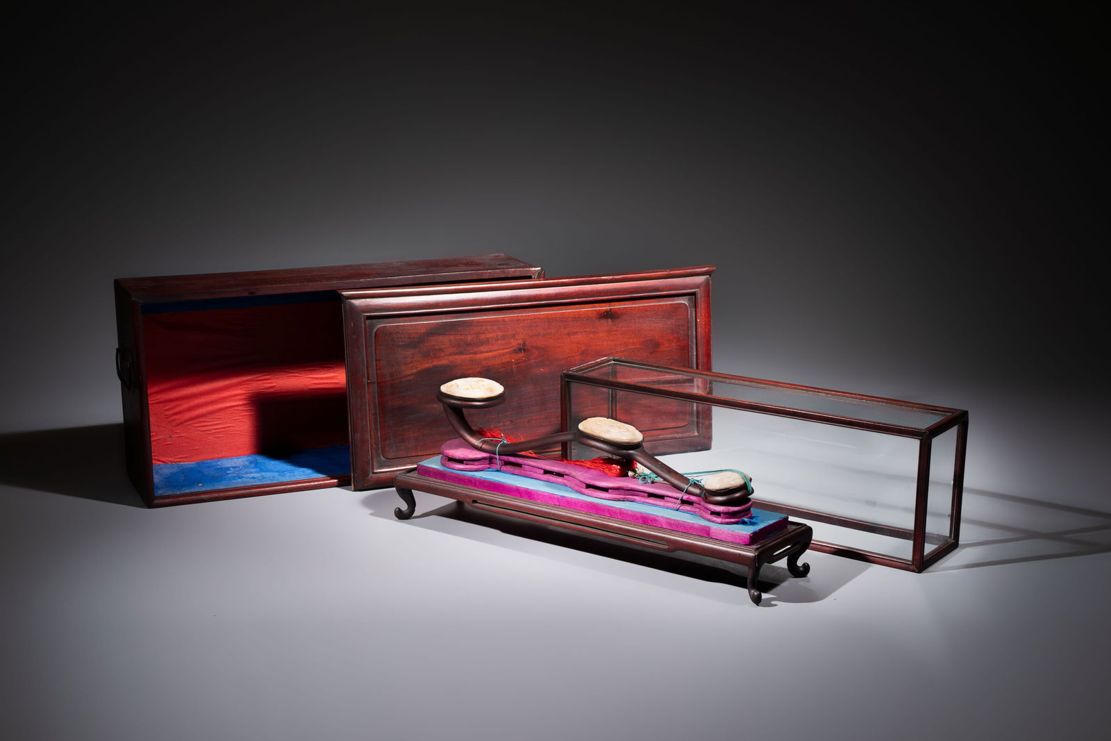 A Chinese white-jade-inset hongmu ruyi with a wooden presentation box and display case, 19th C. (1 of 8)