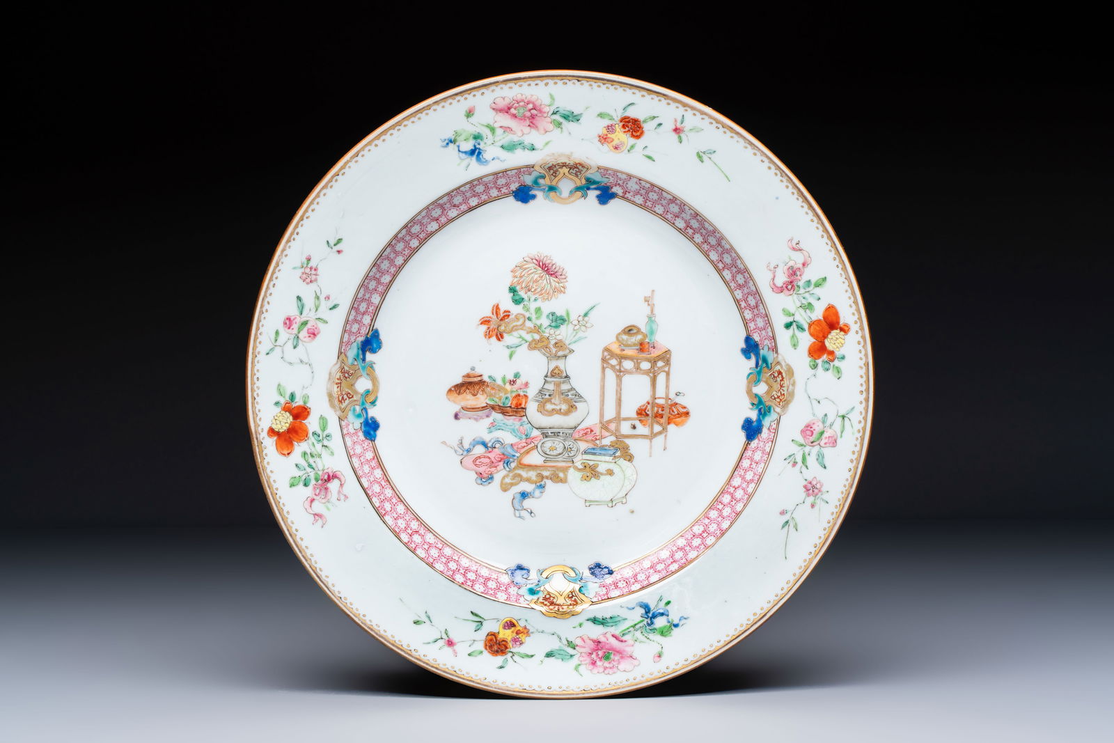 A Chinese famille rose gilt-decorated 'Antiquities' plate, Yongzheng (1 of 2)