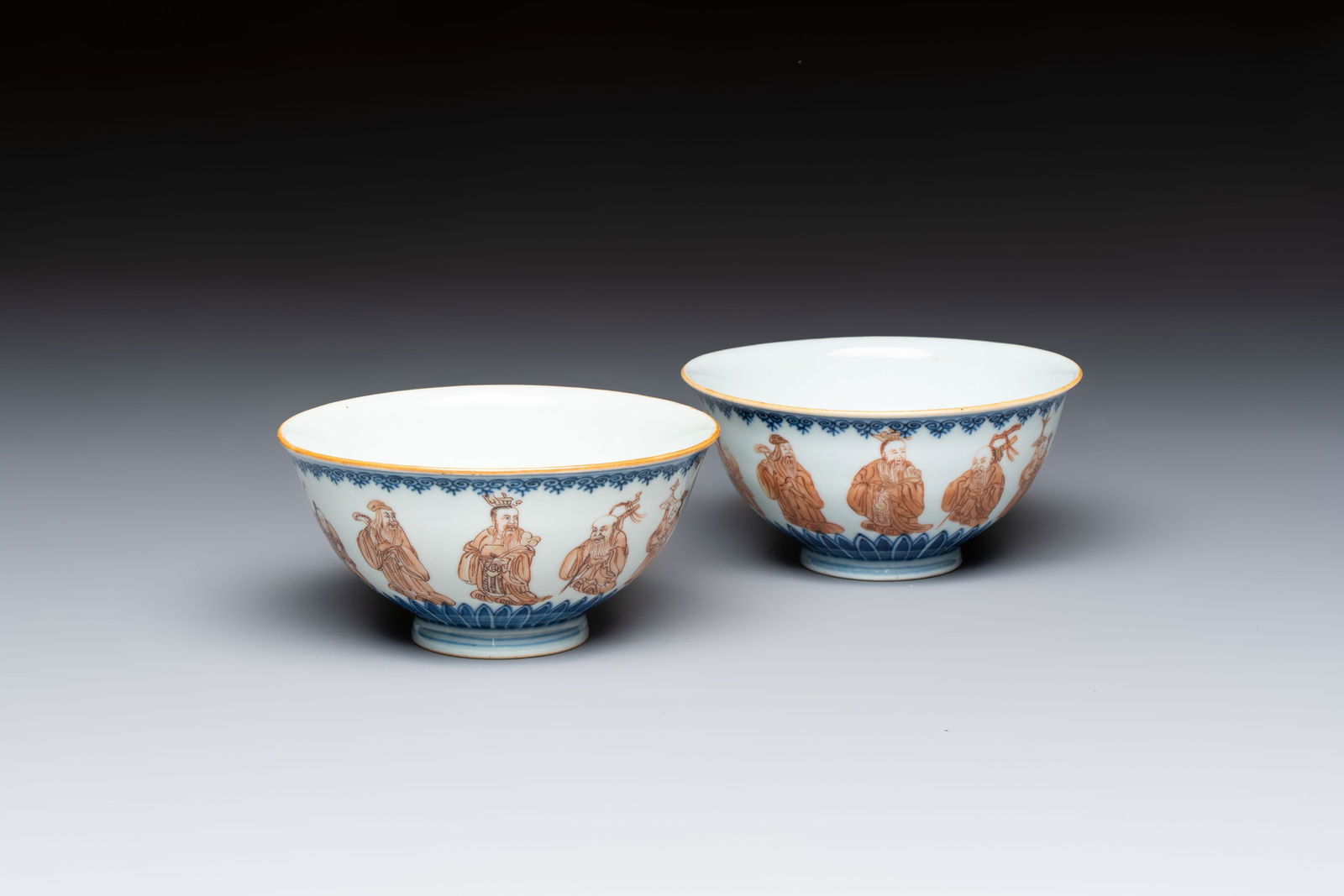 A pair of Chinese blue and white iron-red-decorated 'Three Star Gods' bowls, Qianlong mark and of (1 of 7)