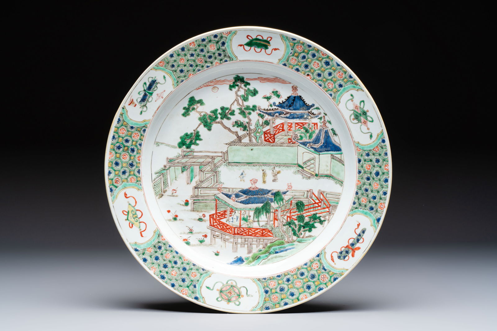 A Chinese famille verte 'Pavilions and Lotus Pond' dish, swastika mark, Kangxi (1 of 2)