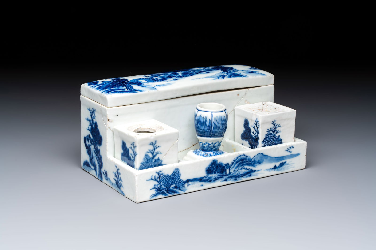 A rare Chinese blue and white 'Mountainous Landscape' writing set with an inkwell, sander and (1 of 9)
