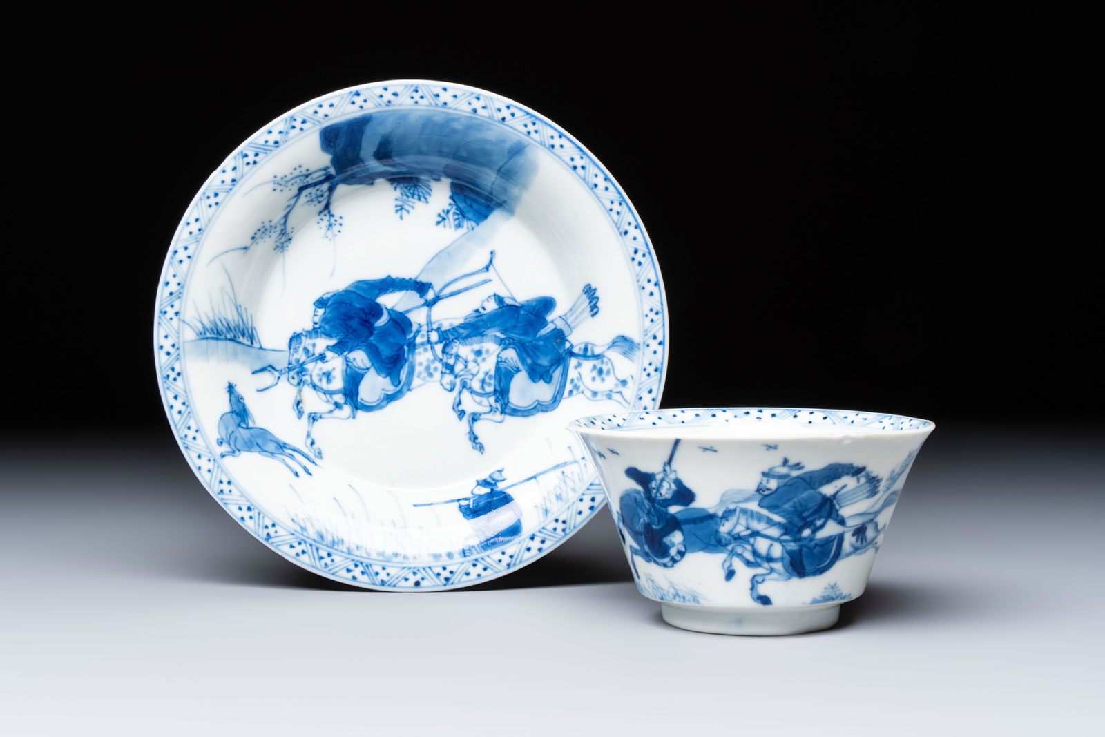 A Chinese blue and white 'Hunting Scene' cup and saucer, Kangxi (1 of 9)