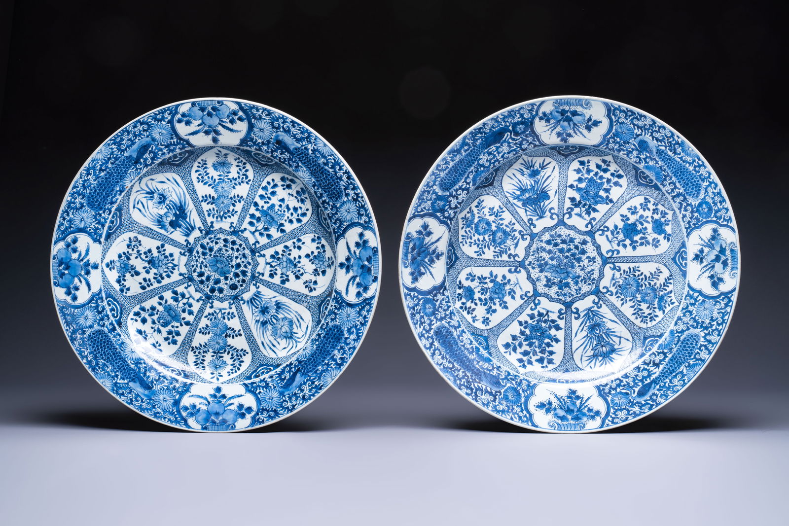 A pair of large Chinese blue and white 'Peacock Border' chargers with floral design, Kangxi: A pair of large Chinese blue and white 'Peacock Border' chargers with floral design, Kangxi Dia.: 47 cm Ref.: Christie's, New York, Sep. 13, 2019, lot 1102, for a similar pair. (sold USD 15.000)