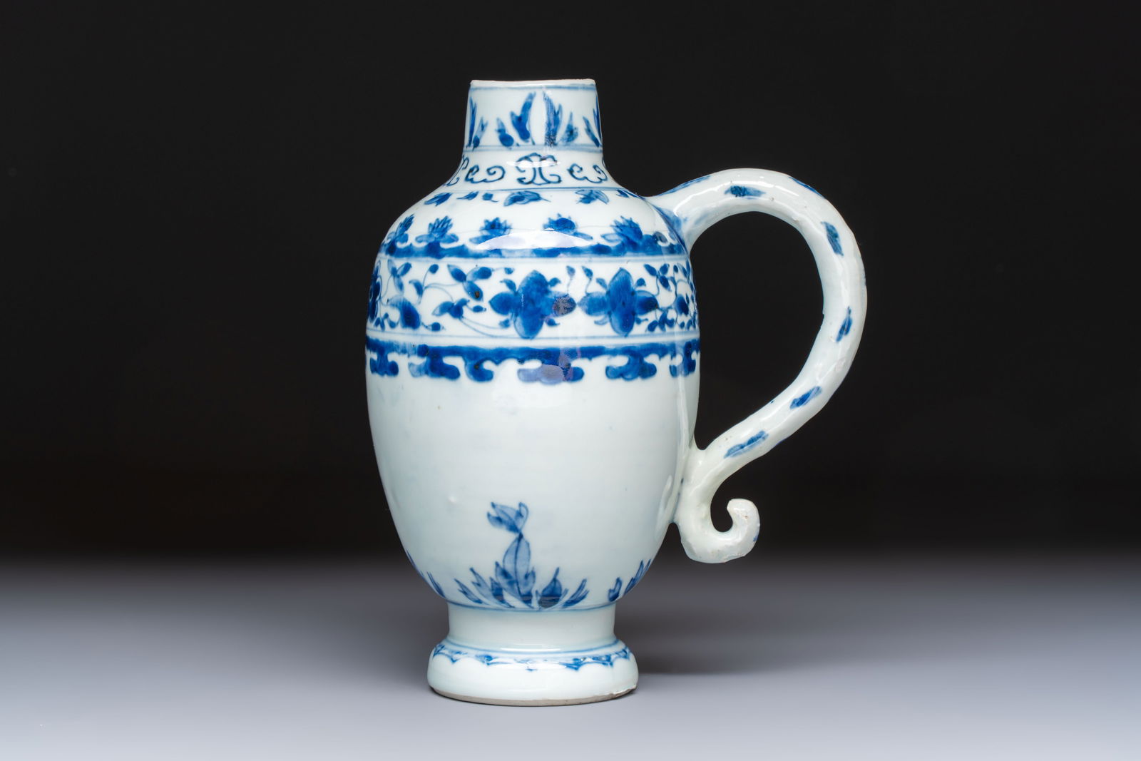 A Chinese blue and white 'Floral' jug, Transitional period (1 of 6)