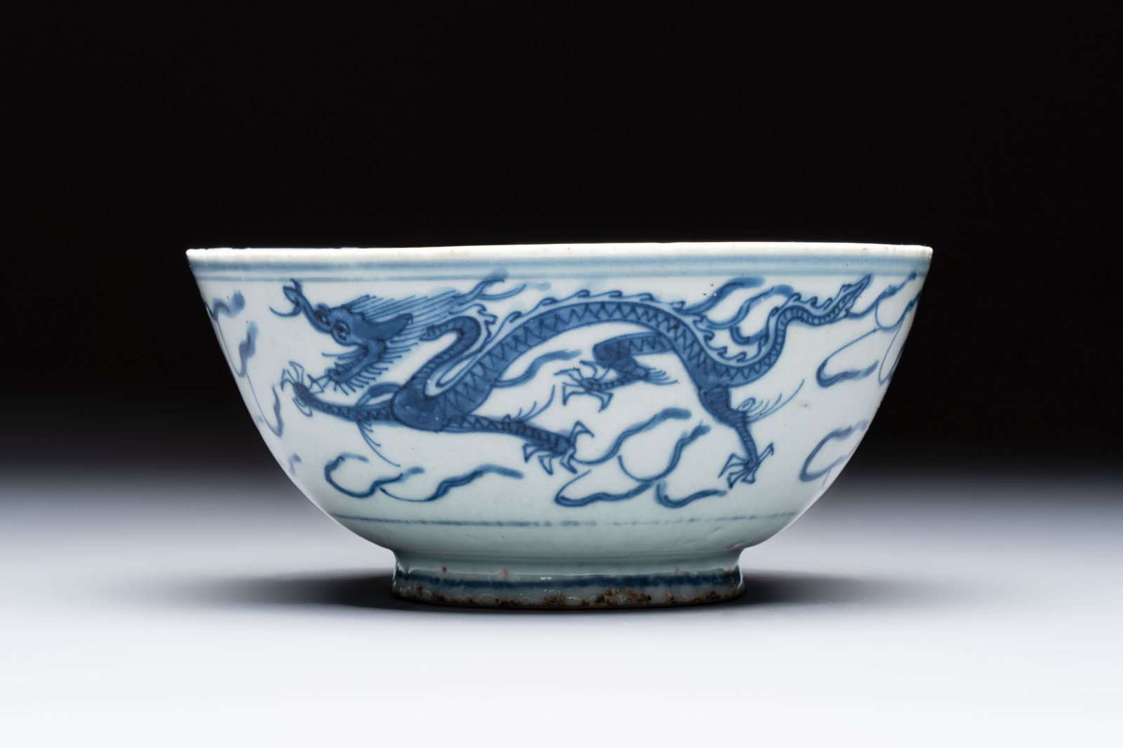 A Chinese blue and white 'Dragons and Clouds' bowl, Jiajing/Wanli (1 of 7)