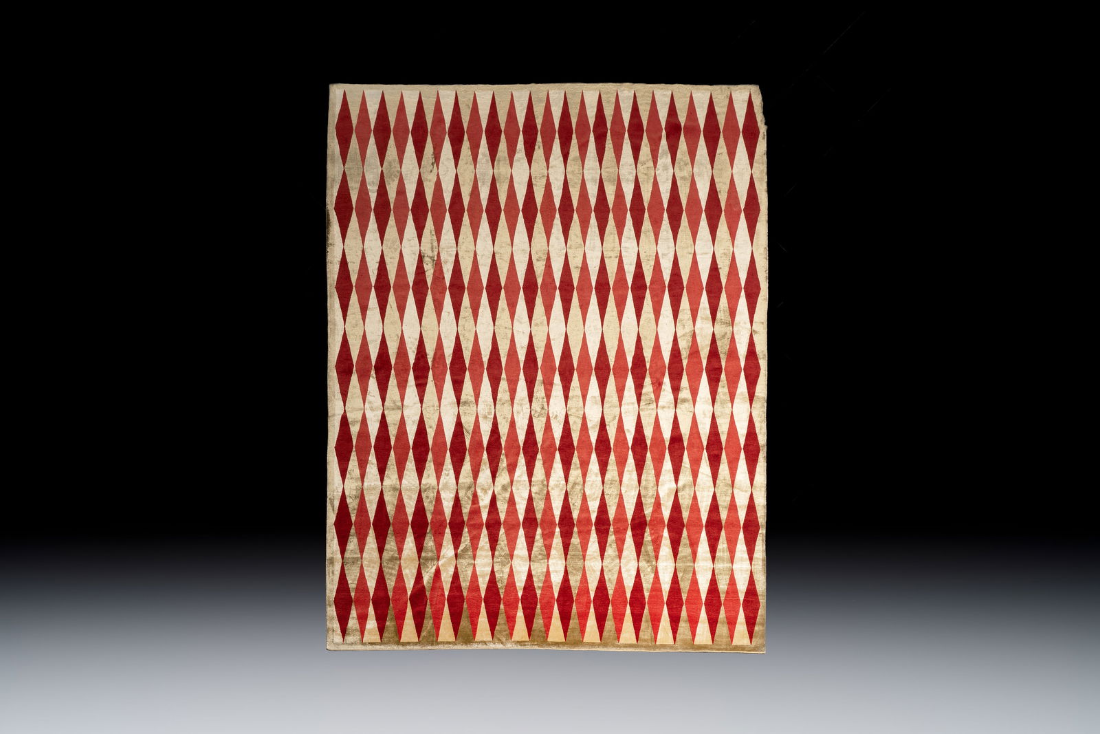 A hand-knotted wool and silk carpet with a rhombic design, Ferdows, Iran, 20th C. (1 of 4)